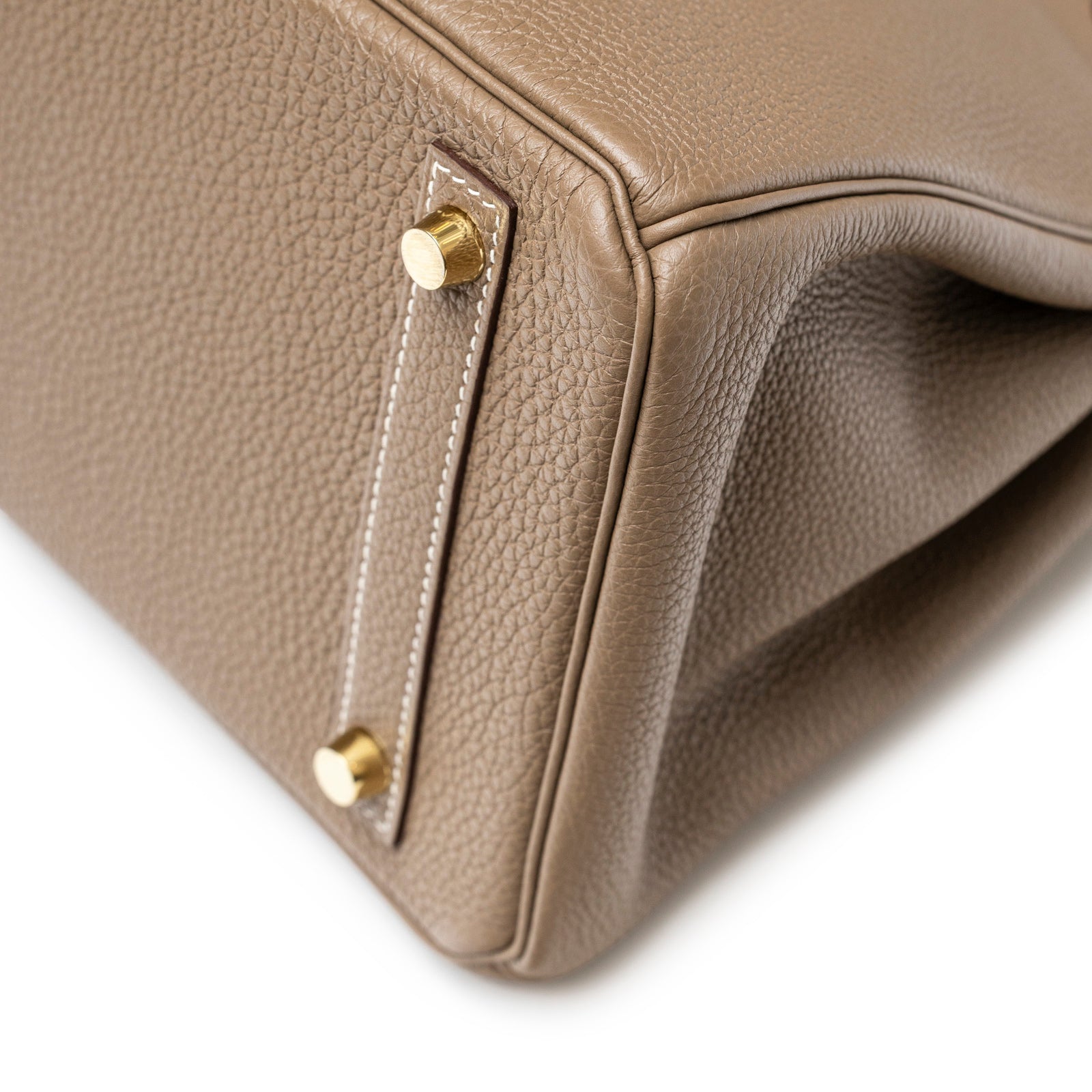 Close-up bottom corner of Hermès Birkin 30 Etoupe Togo Gold Hardware showing leather texture and gold feet detail