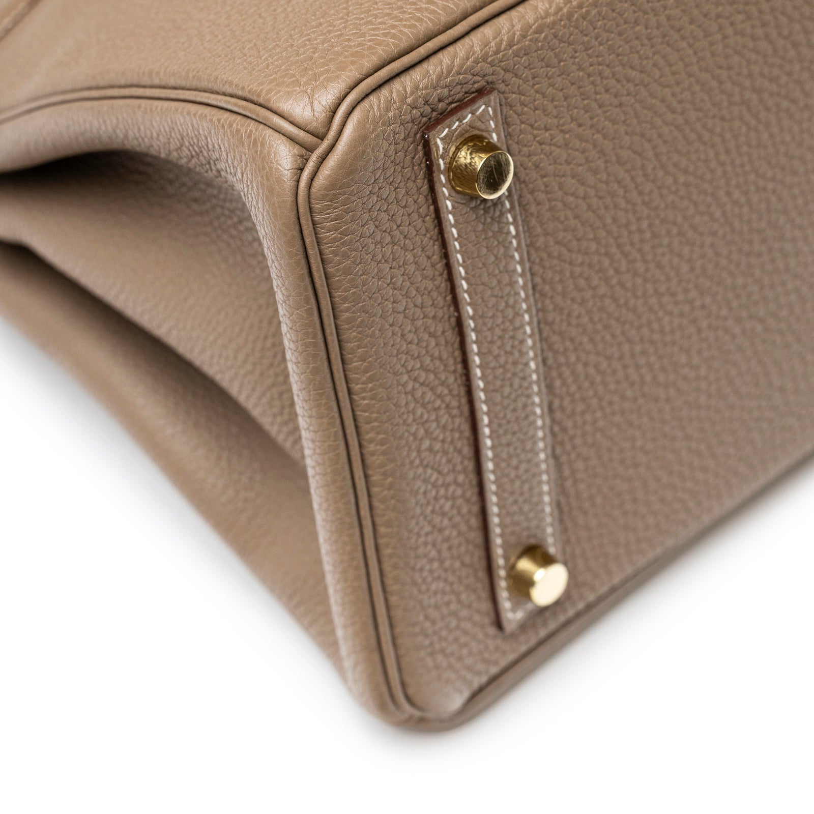 Close-up bottom corner view of Hermès Birkin 30 Etoupe Togo Gold Hardware showing pebbled leather and gold feet