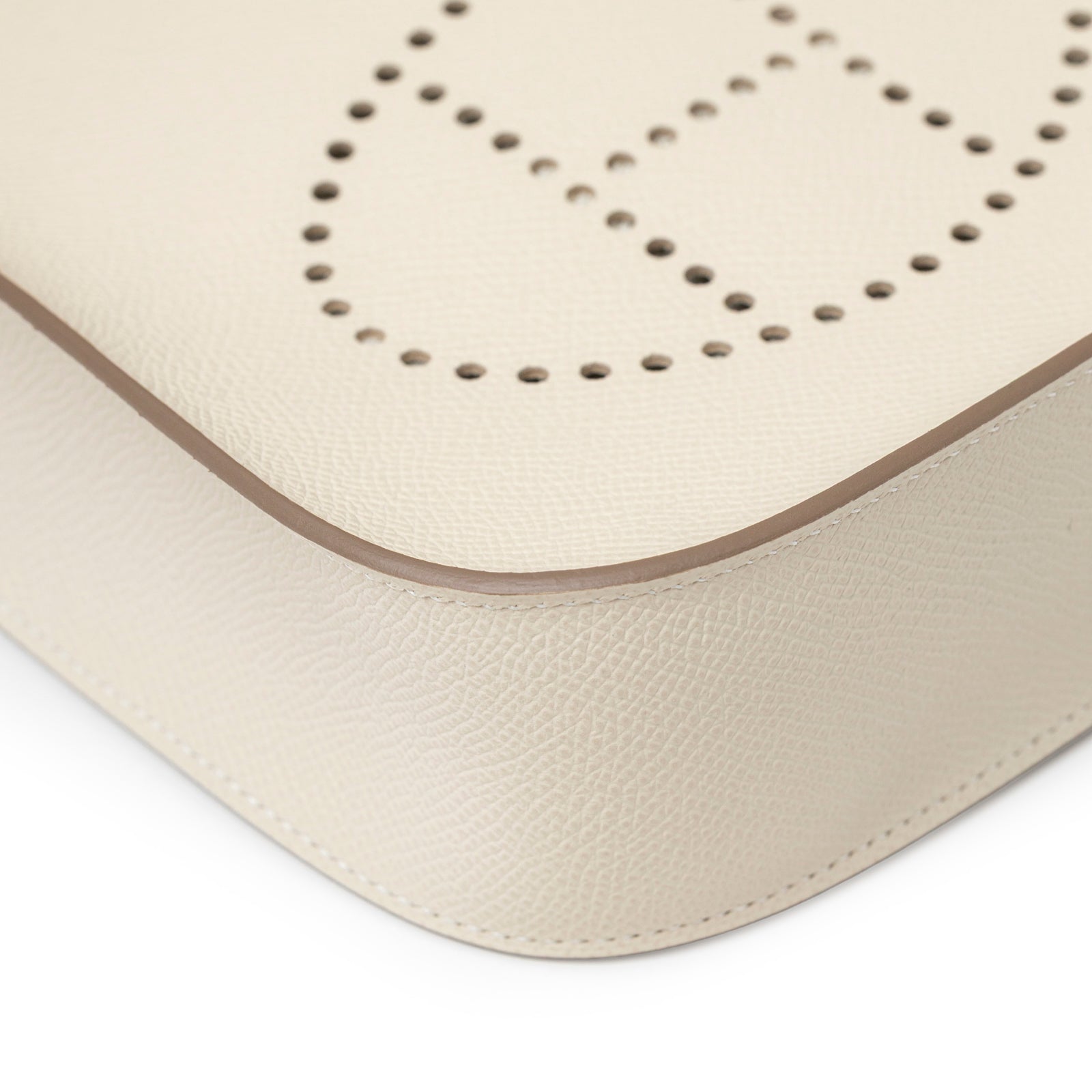Close-up of Hermès Mini Evelyne Sellier Craie Epsom Gold Hardware corner showing leather texture and perforated logo