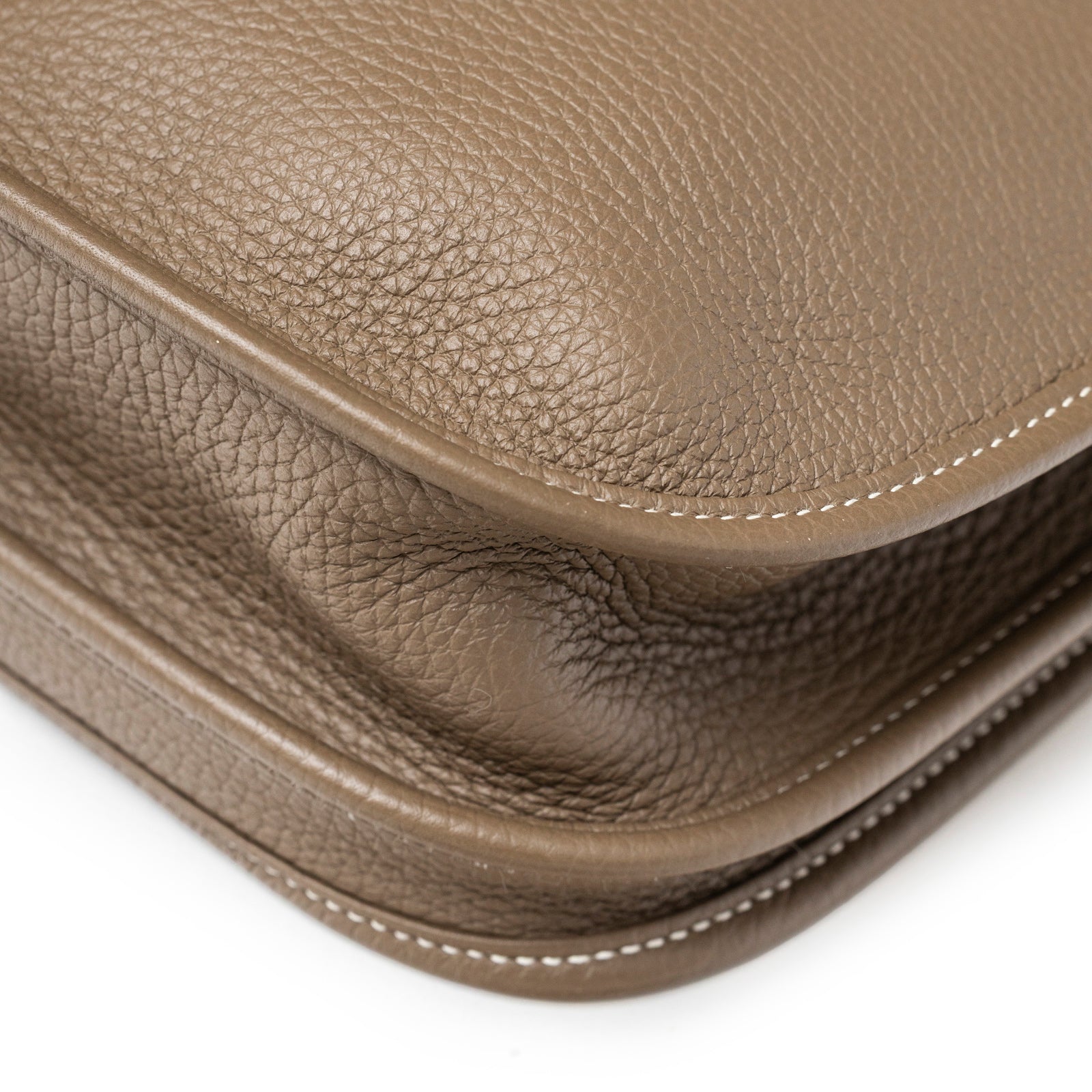 Close-up angled view of Hermès Evelyne PM 29 Etoupe Clemence Palladium Hardware showing pebbled leather and stitching detail