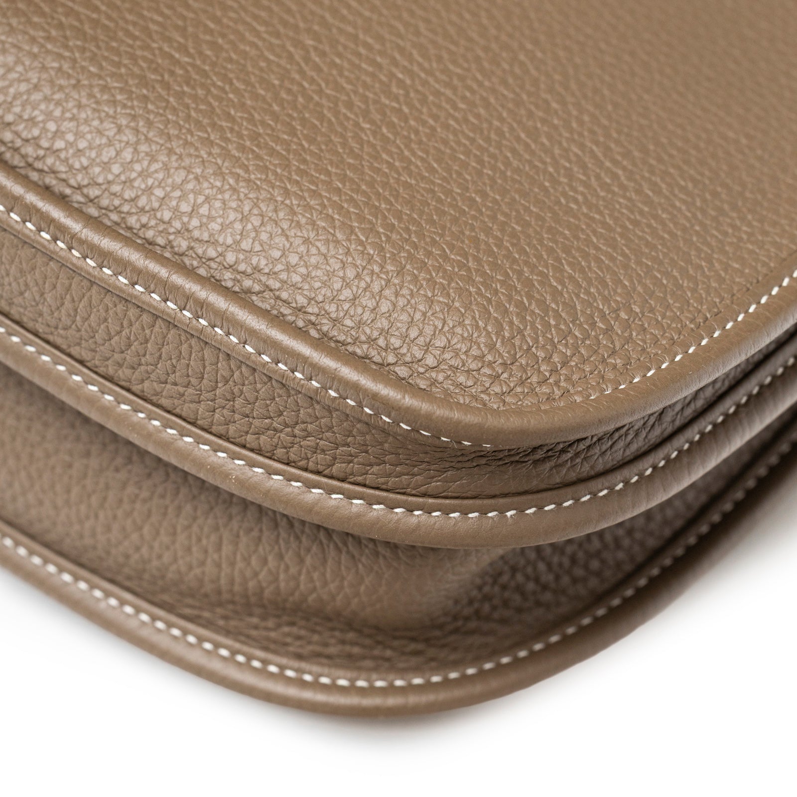 Close-up angled view of Hermès Evelyne PM 29 Etoupe Clemence Palladium Hardware pebbled leather and stitching detail