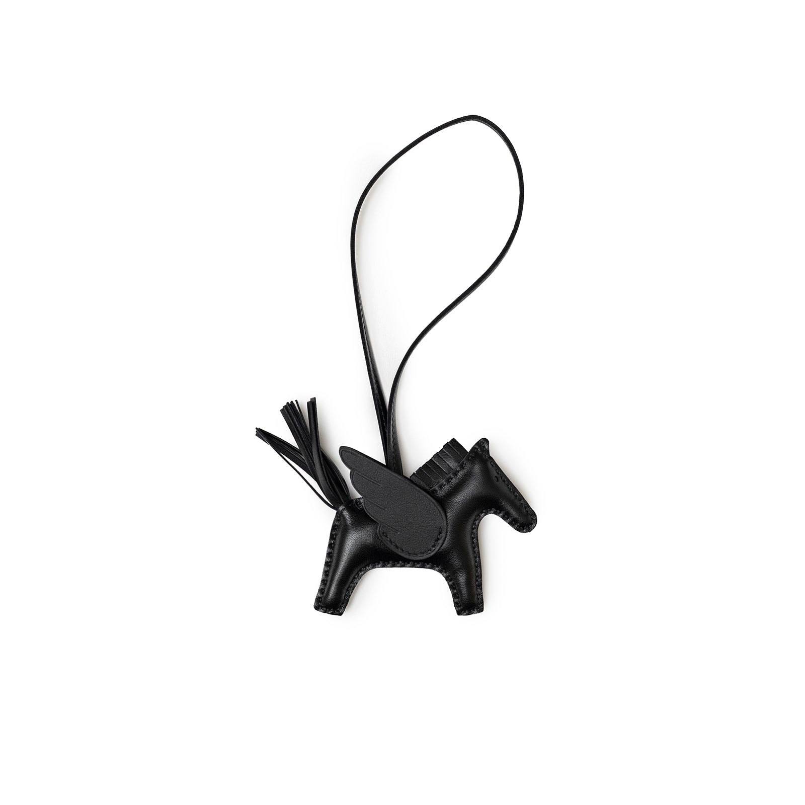 Angled shot of Hermès Rodeo Pegase Bag Charm PM So Black Milo Lambskin shaped like a horse with wing detail.