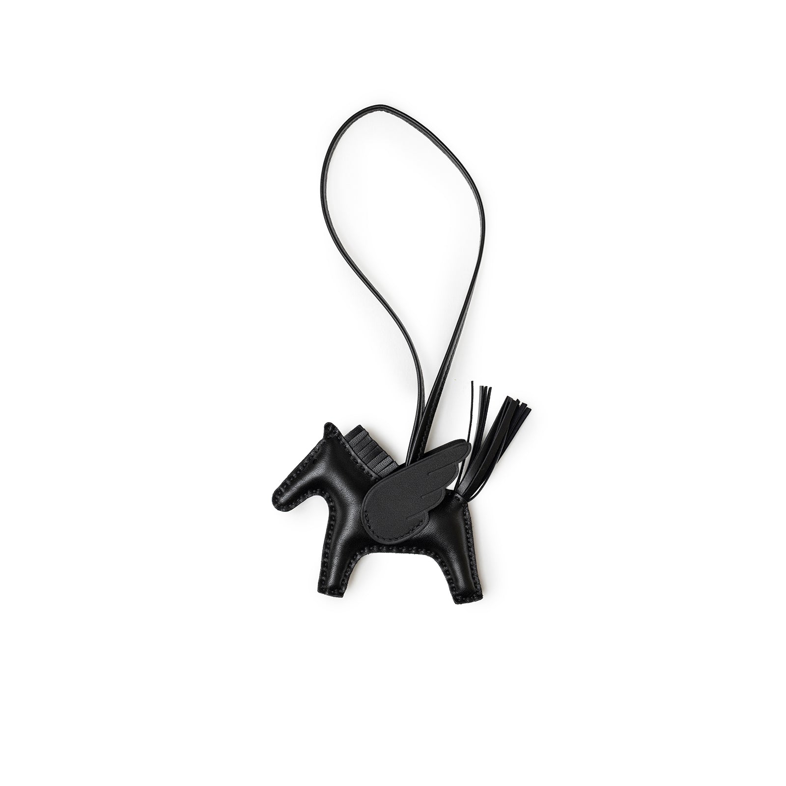 Angled view of Hermès Rodeo Pegase Bag Charm PM So Black leather horse with wing and hanging loop