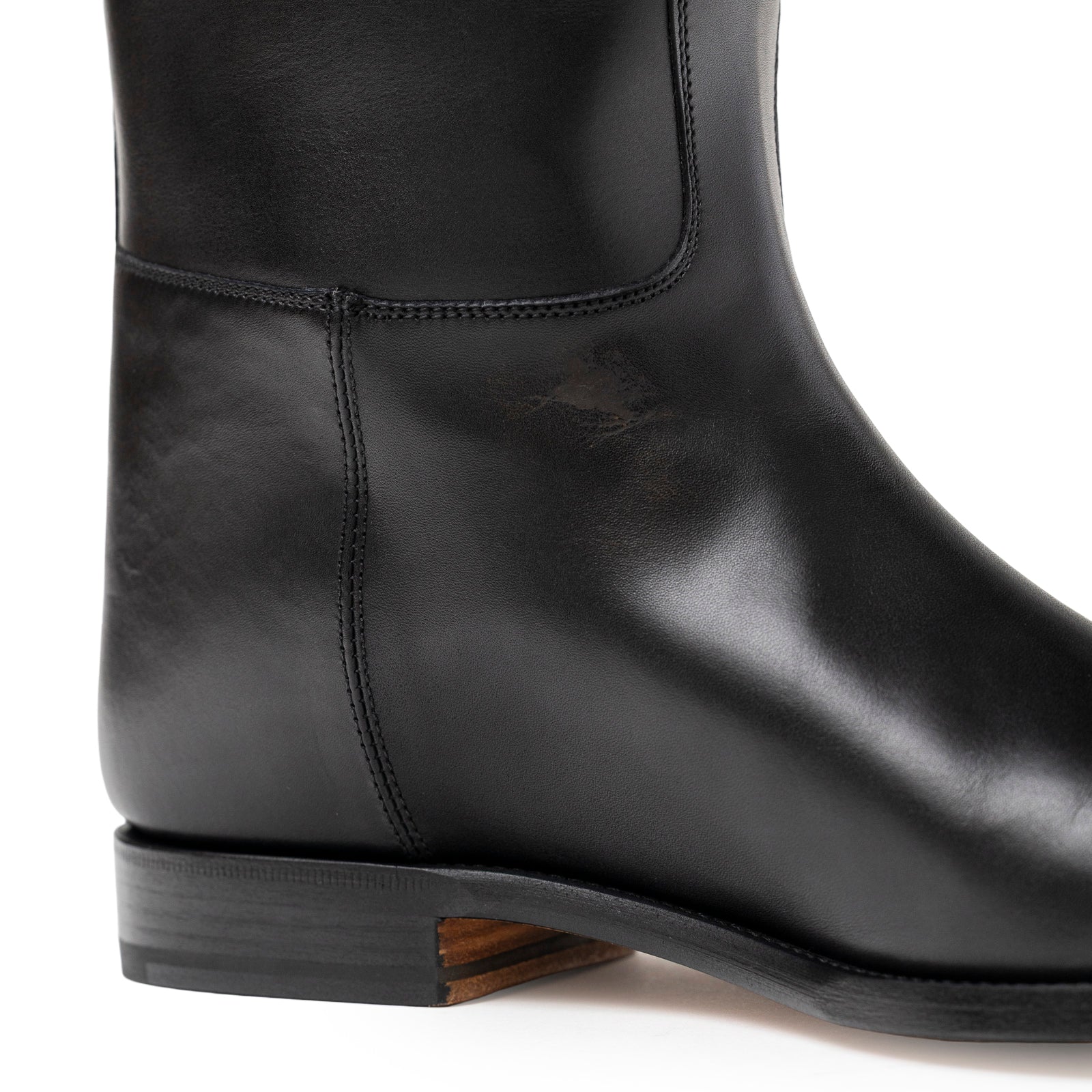 Close-up side view of Hermès Kelly Jumping Boot Black Box Palladium Plated showing smooth leather and stitching detail