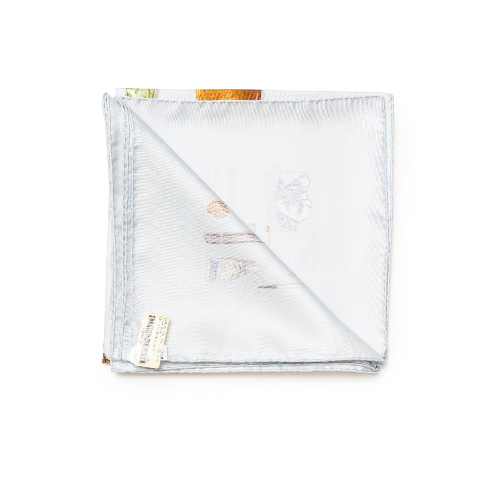 Top-down view of folded Hermès Carre Scarf 90 In The Pocket Blue Glacier/Blue Pale showing fabric and edge details