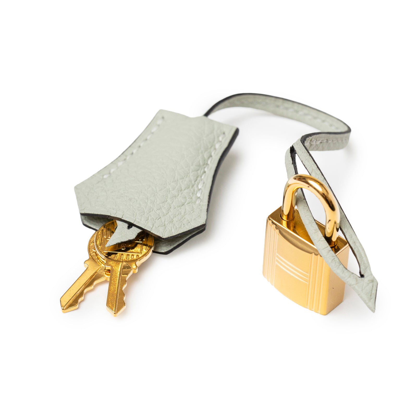 Close-up angled view of Hermès Birkin 25 Gris Neve Togo Gold Hardware lock with clochette and keys detail