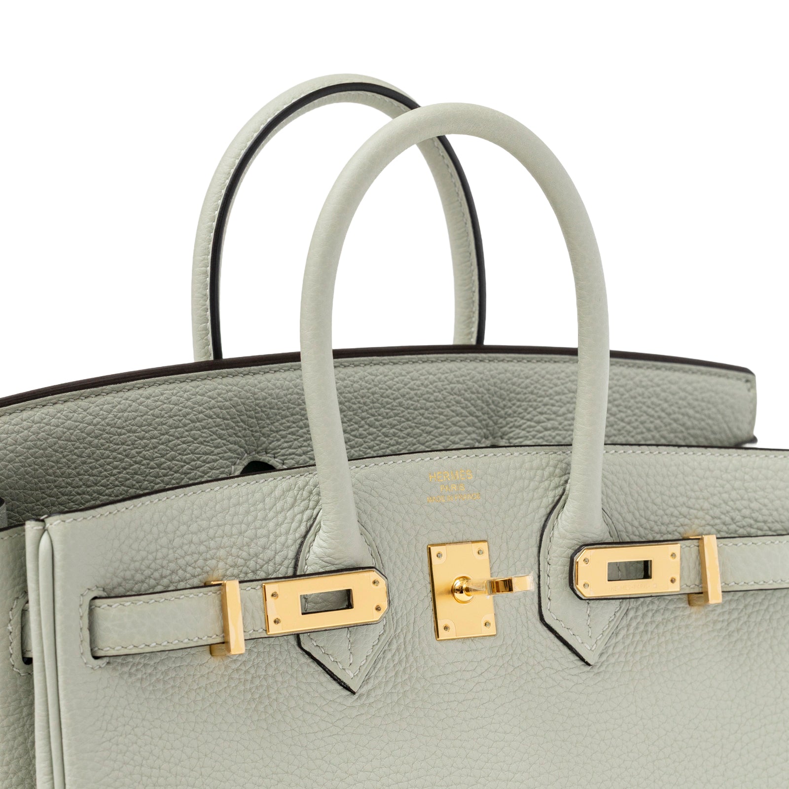 Close-up angled view of Hermès Birkin 25 Gris Neve Togo Gold Hardware clasp and handles detail