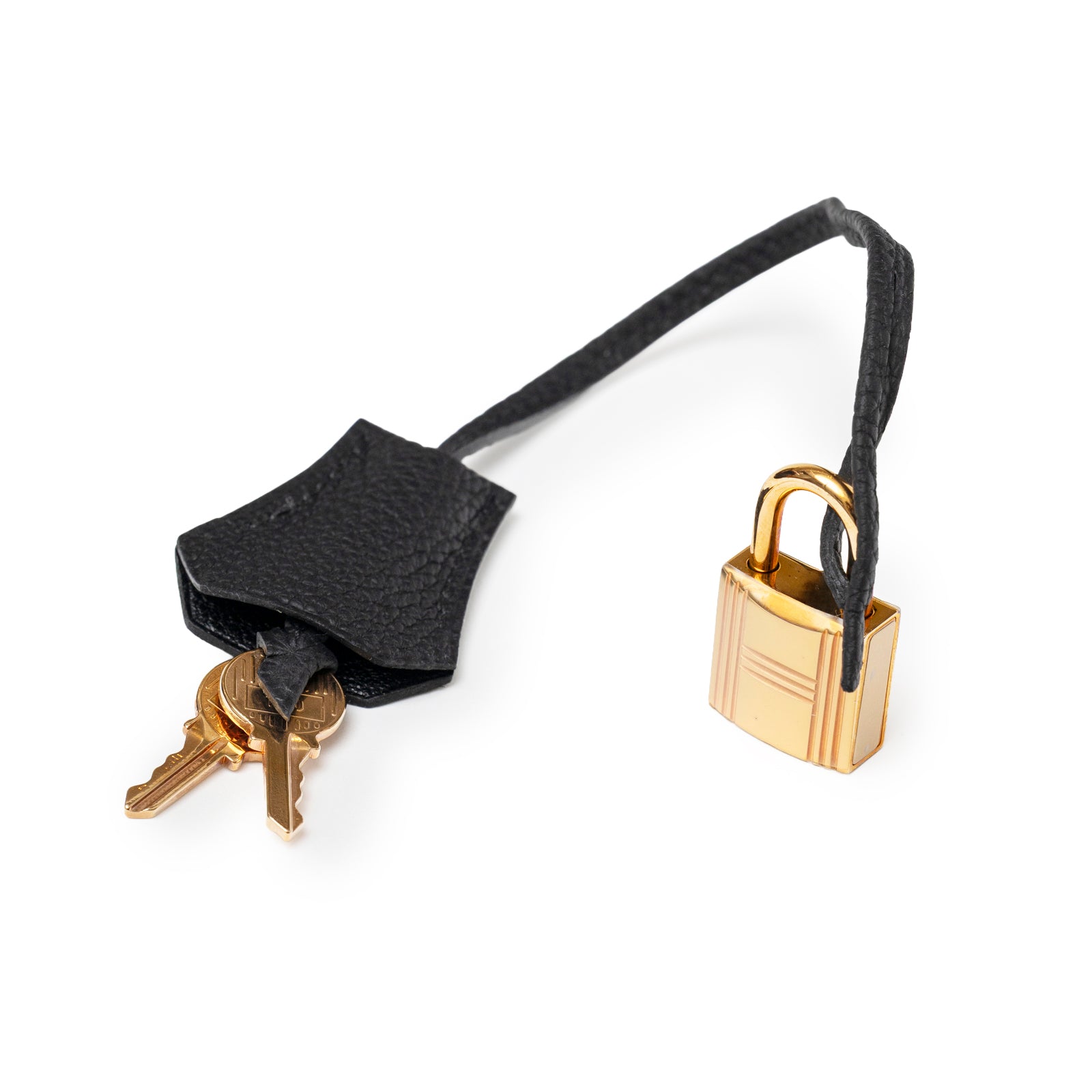 Close-up of Hermès Birkin 30 Black Togo Rose Gold Hardware padlock and keys with leather clochette on white background