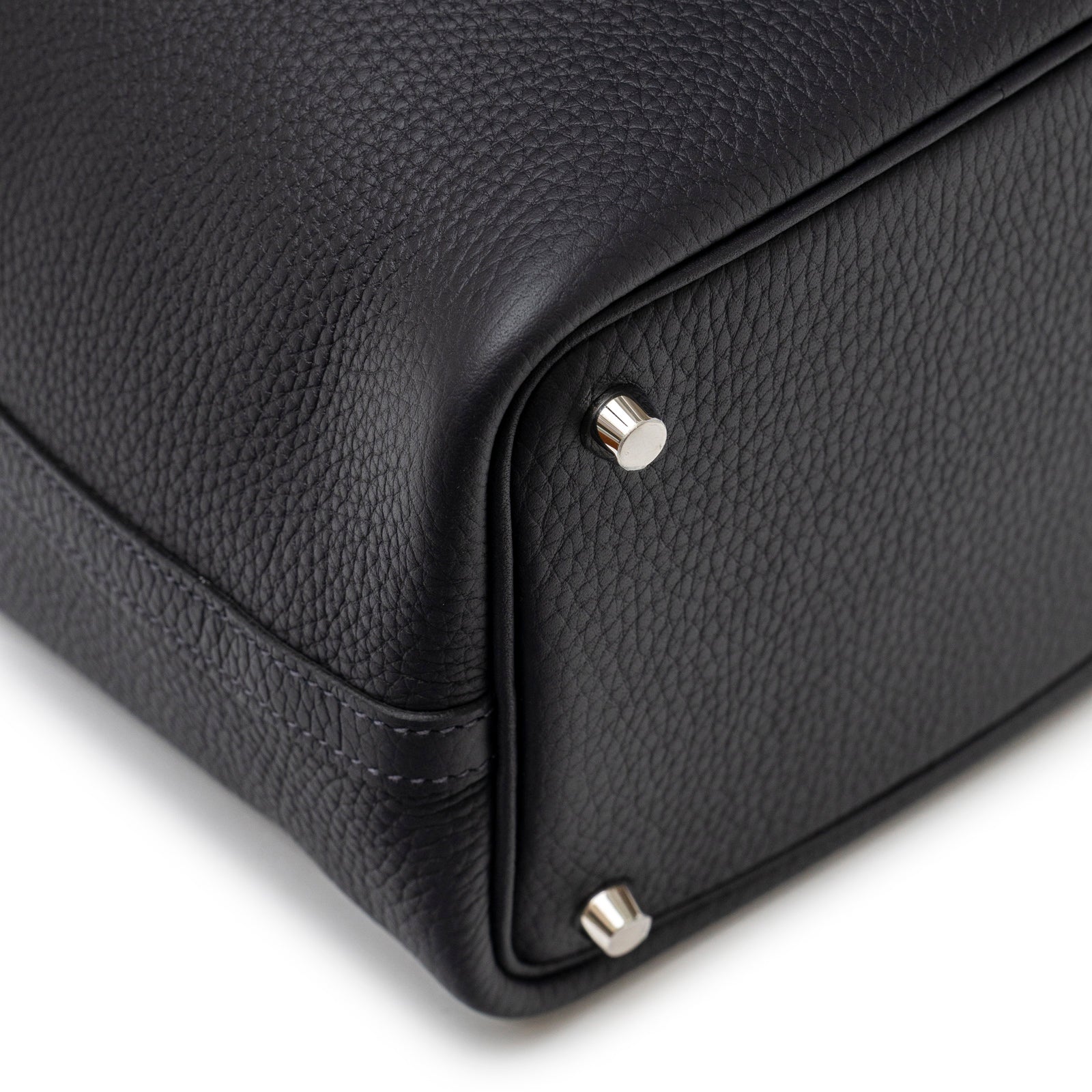 Close-up angled view of bottom corner and palladium feet on Hermès Picotin 18 Plomb Clemence Palladium Hardware