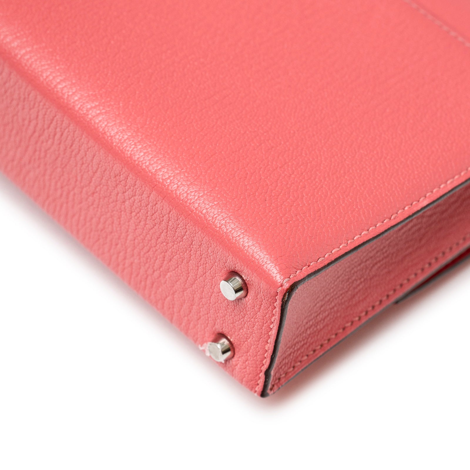 Close-up angled view of Hermès Mini Verrou Chaine Bag Rose Azalee Chevre Mysore Palladium Hardware corner studs and stitching detail