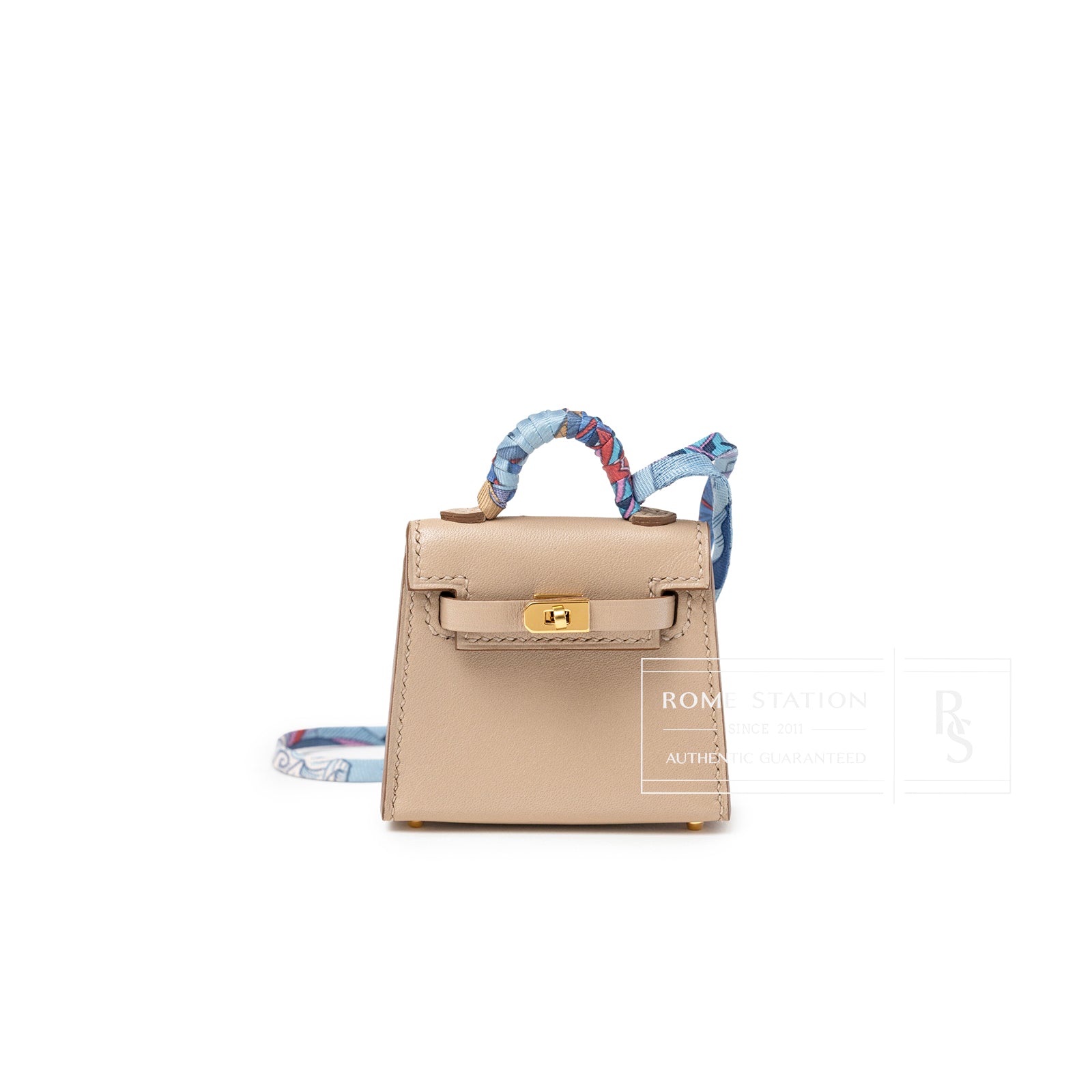 Front view of Hermès Mini Kelly Twilly Bag Charm Argile Tadelakt Gold Hardware with wrapped handle detail