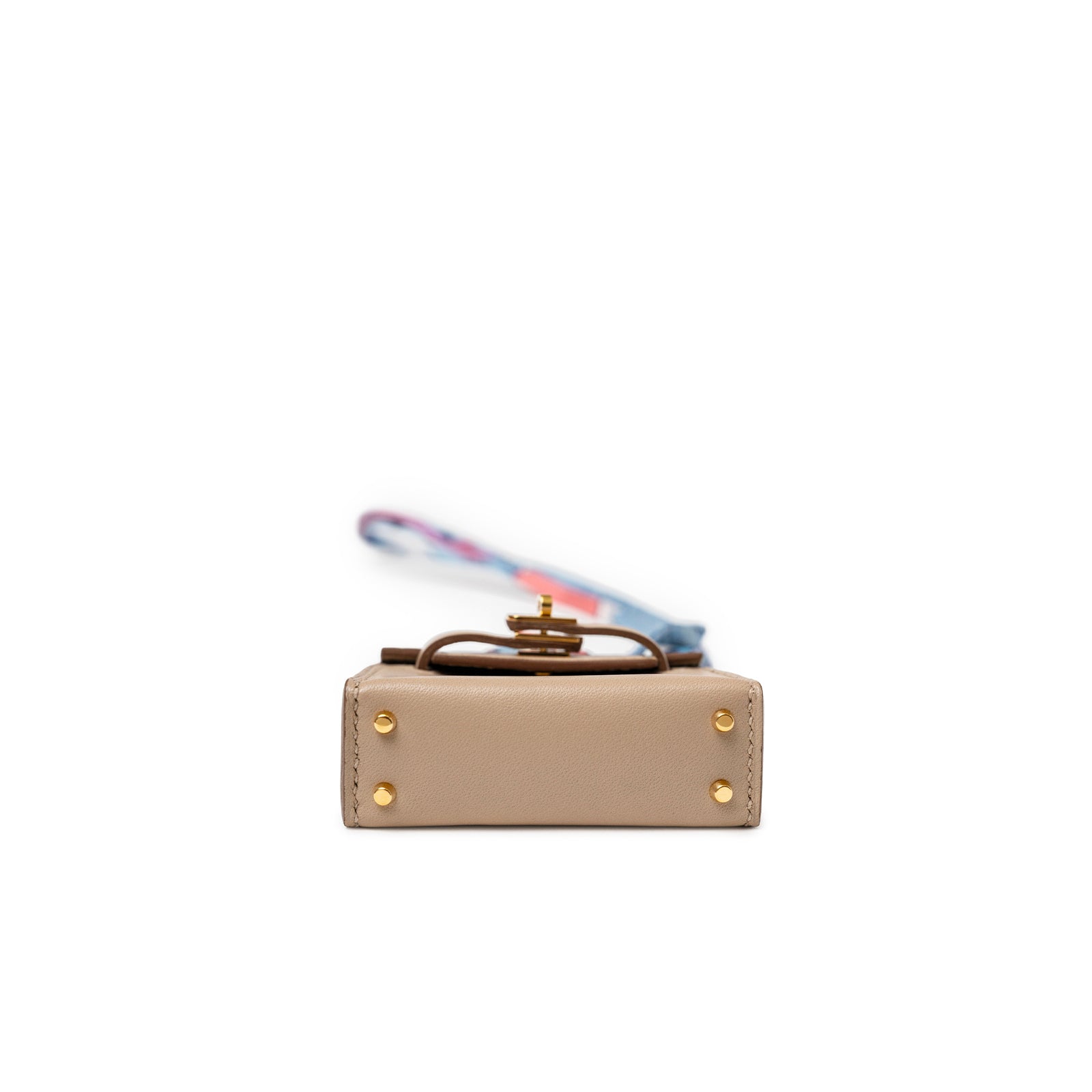 Bottom view of Hermès Mini Kelly Twilly Bag Charm Argile Tadelakt Gold Hardware with colorful twilly strap