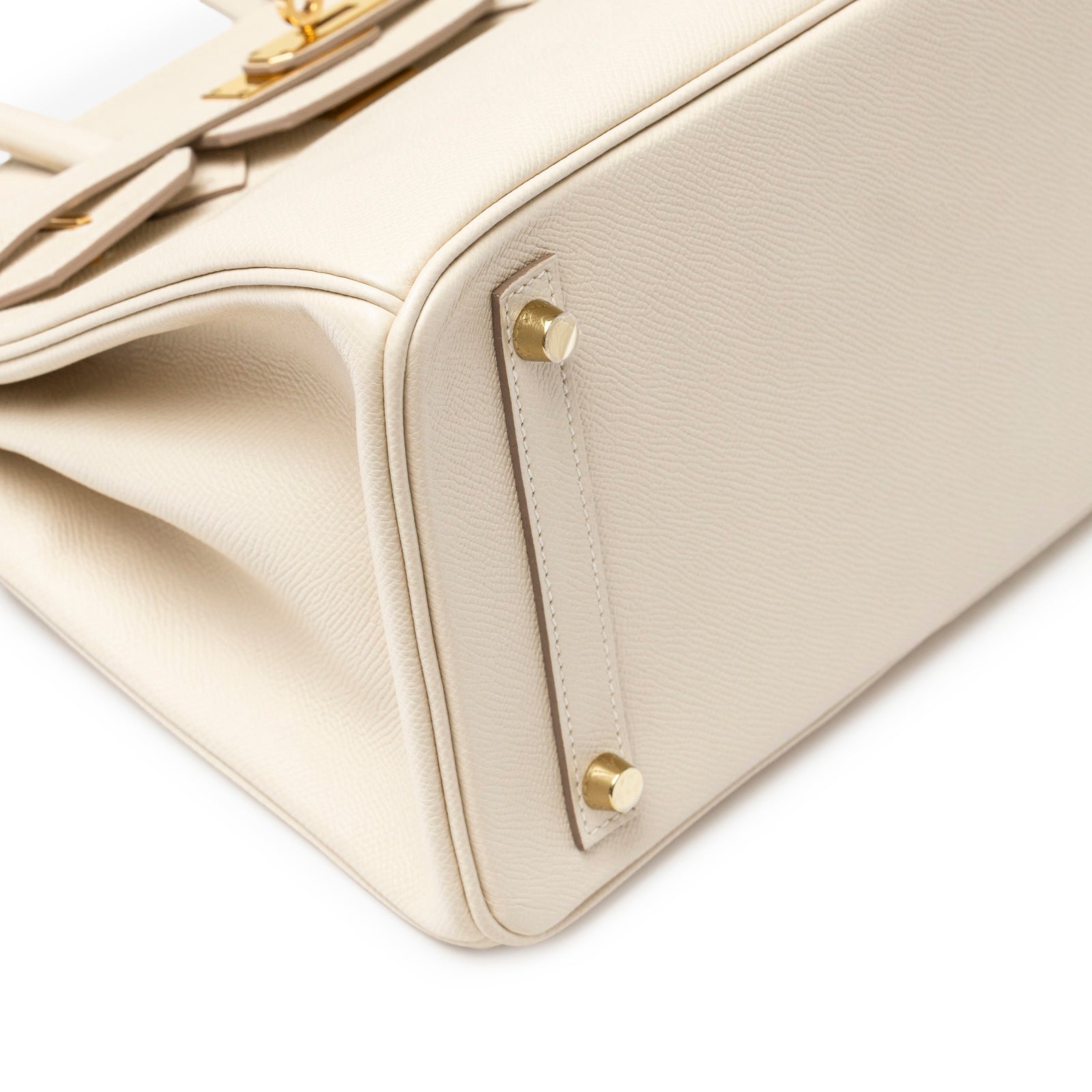 Close-up of bottom corner showing textured leather and gold feet on Hermès Birkin 30 Craie Epsom Gold Hardware