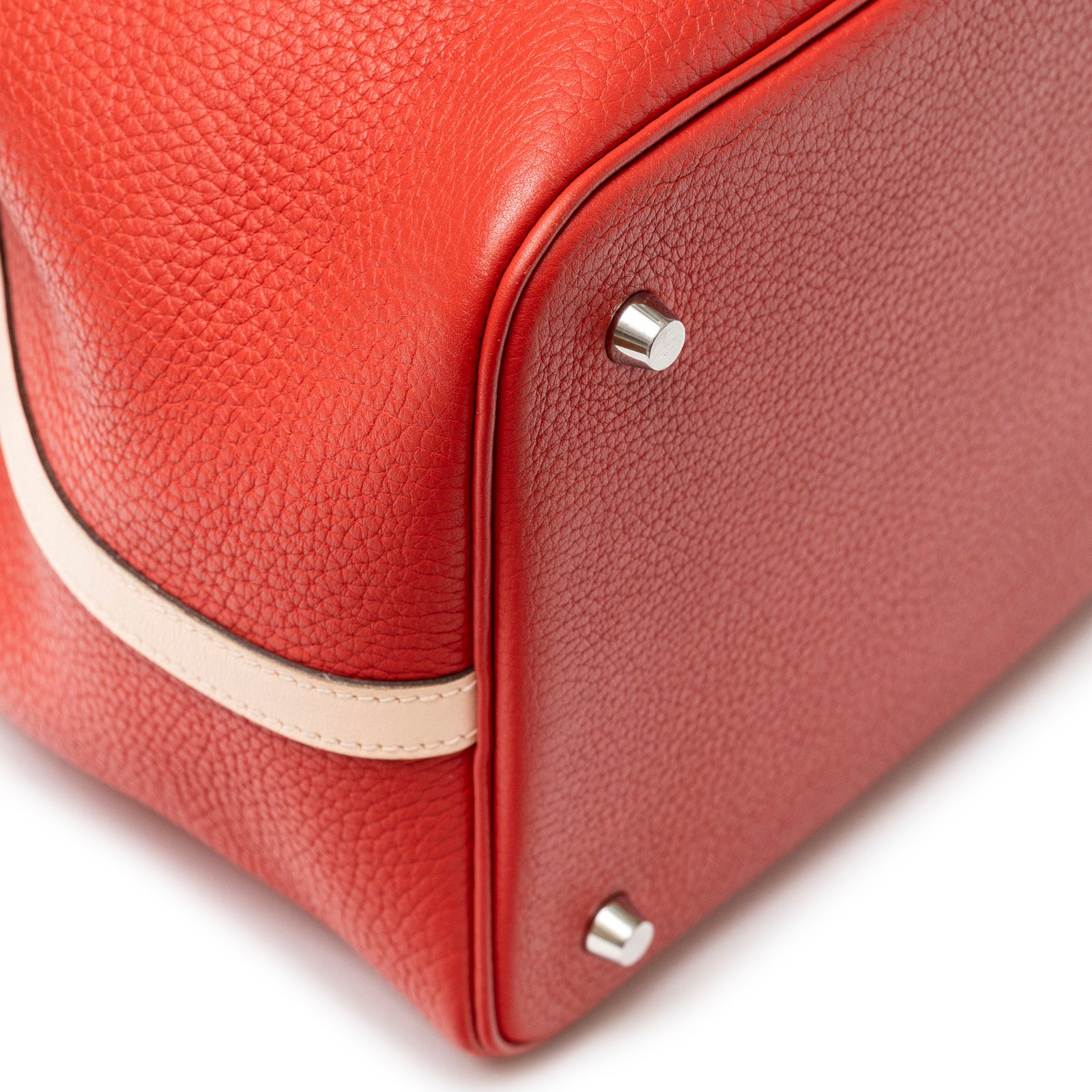 Close-up of bottom corner showing textured leather and palladium hardware on Hermès Picotin 22 Rouge Tomate Rose Elegante Clemence Palladium Hardware