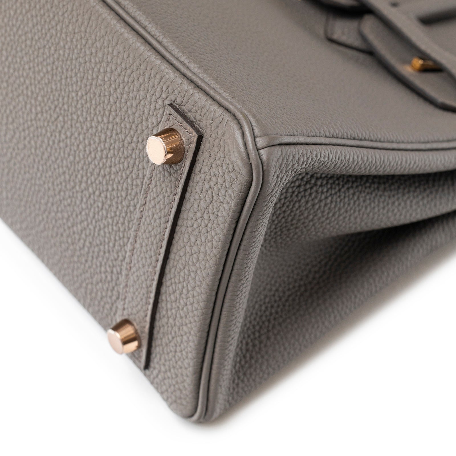 Close-up of bottom corner with rose gold studs on Hermès Birkin 25 Etain Togo Rose Gold Hardware bag