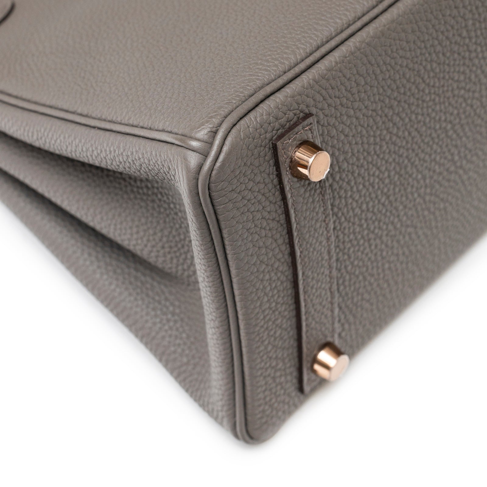 Close-up of corner and rose gold feet on Hermès Birkin 25 Etain Togo Rose Gold Hardware bag showing leather texture