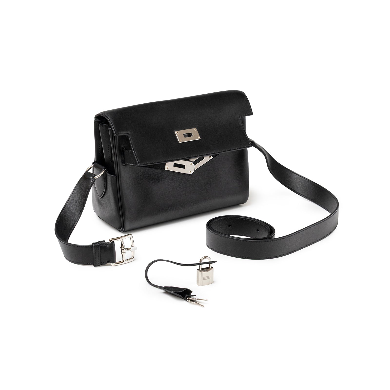 Angled shot of Hermès Kelly Messenger PM Black Evergrain Palladium Hardware with strap, lock, and keys displayed