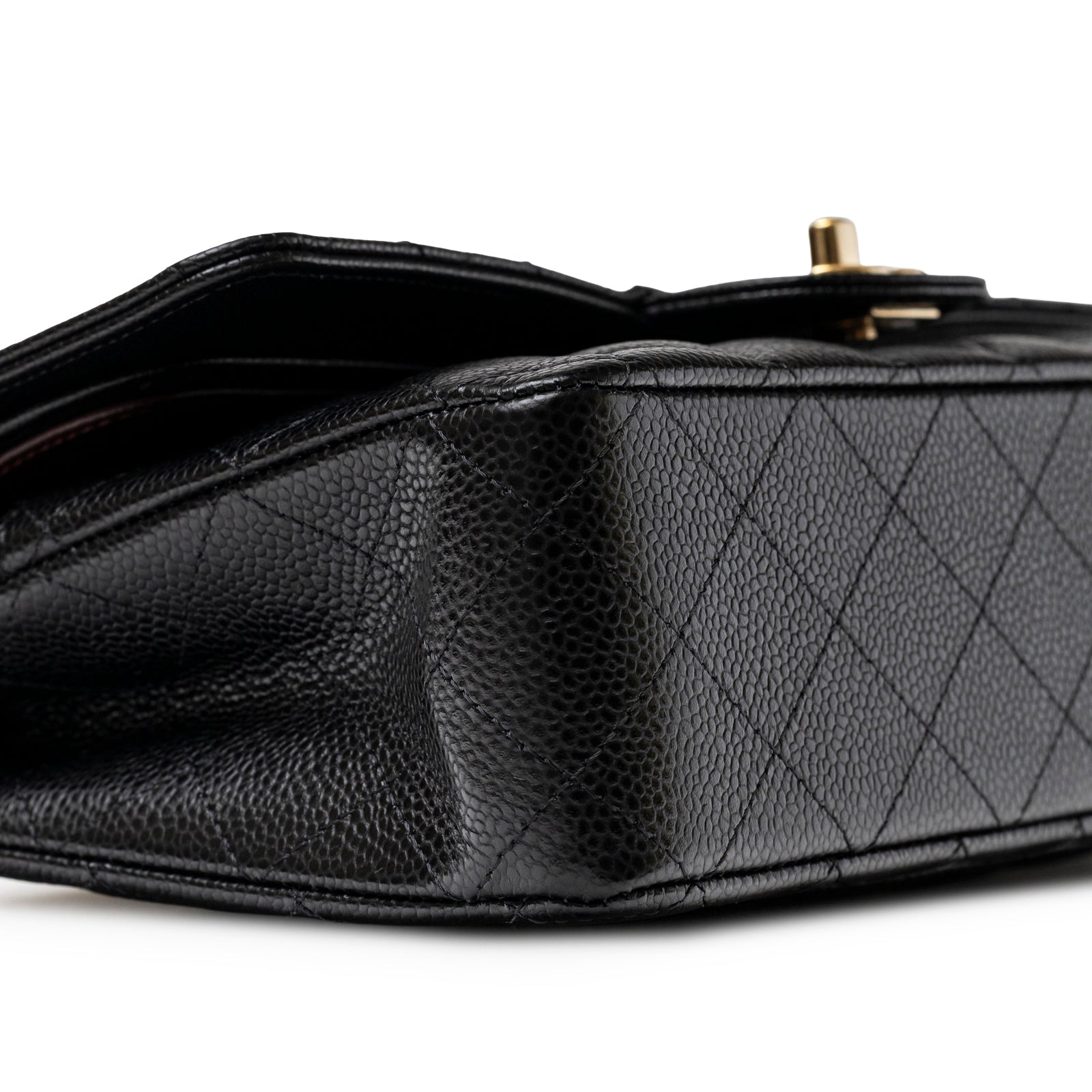 Close-up side view of Chanel Classic Flap Medium Caviar Black Gold Hardware showing texture and stitching detail