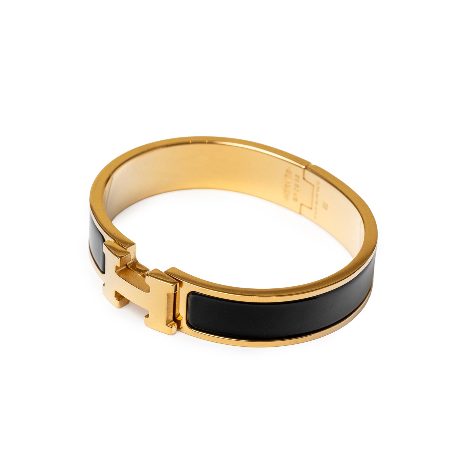 Angled shot of Hermès Clic H bracelet PM Black Gold Hardware showing black enamel and gold clasp details