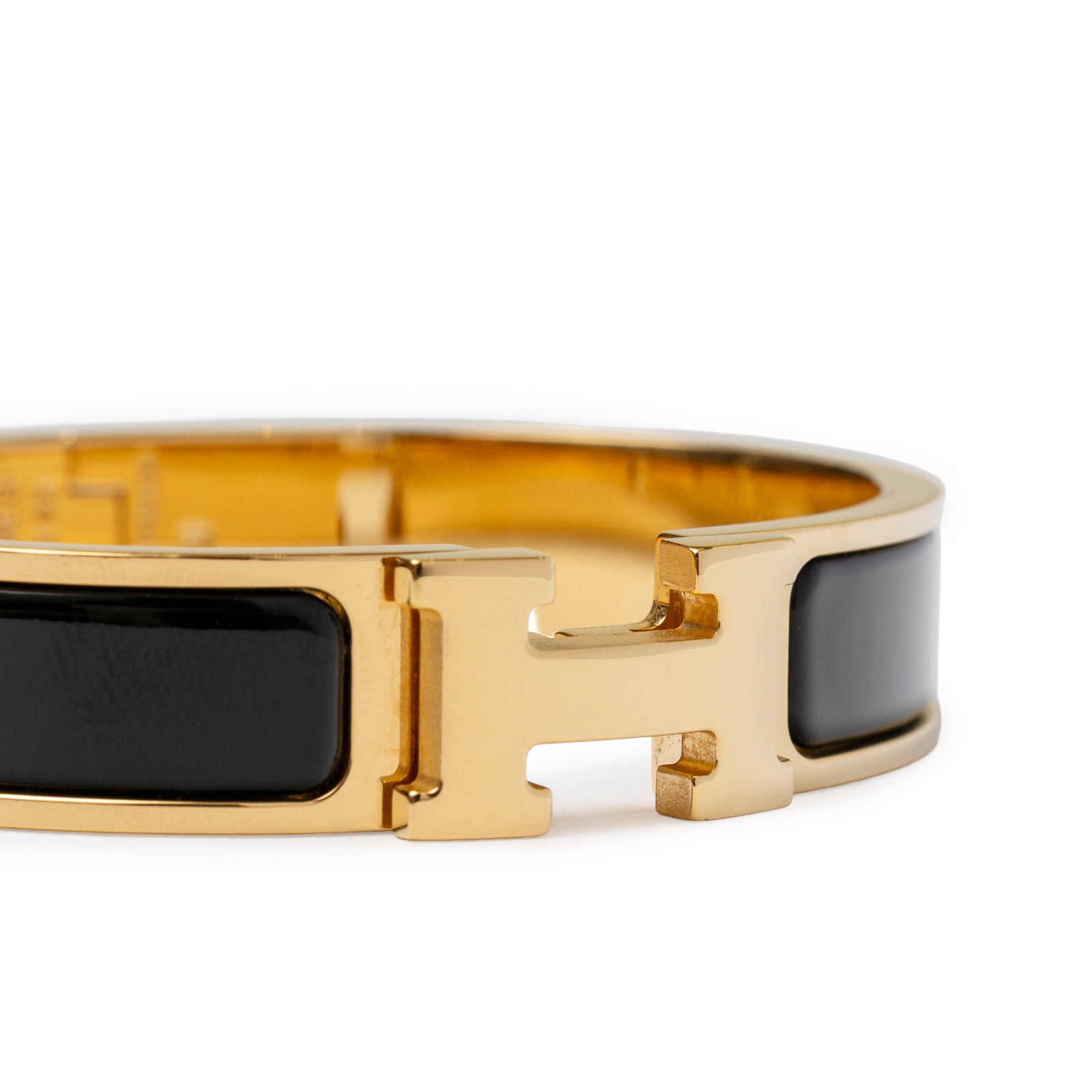Close-up front view of Hermès Clic H bracelet PM Black Gold Hardware showing signature H clasp detail