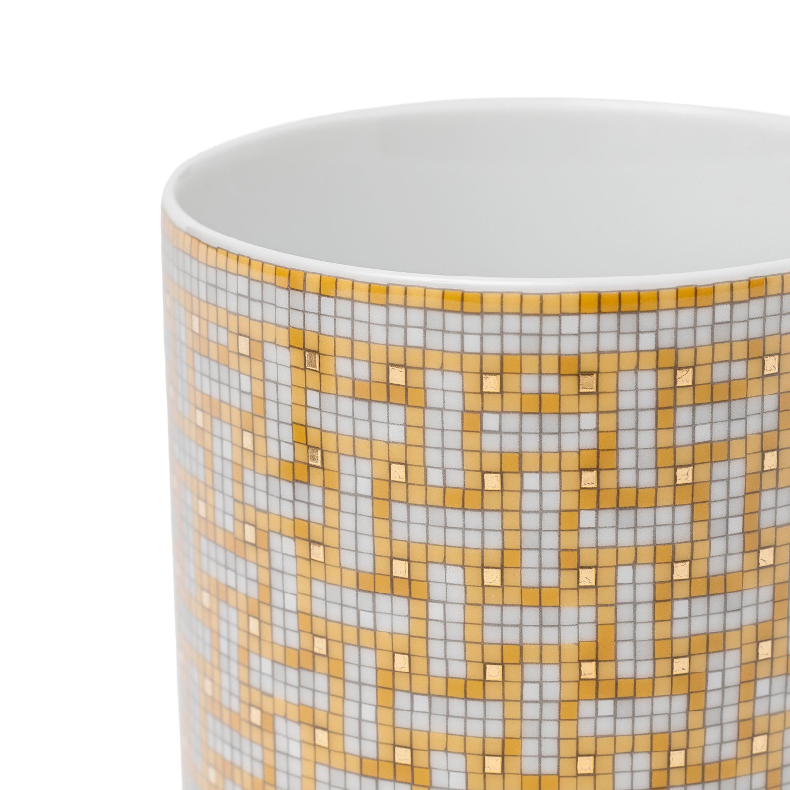 Close-up angled shot of Hermès Mosaique au 24 Gold Mug showing intricate gold mosaic pattern and smooth white interior