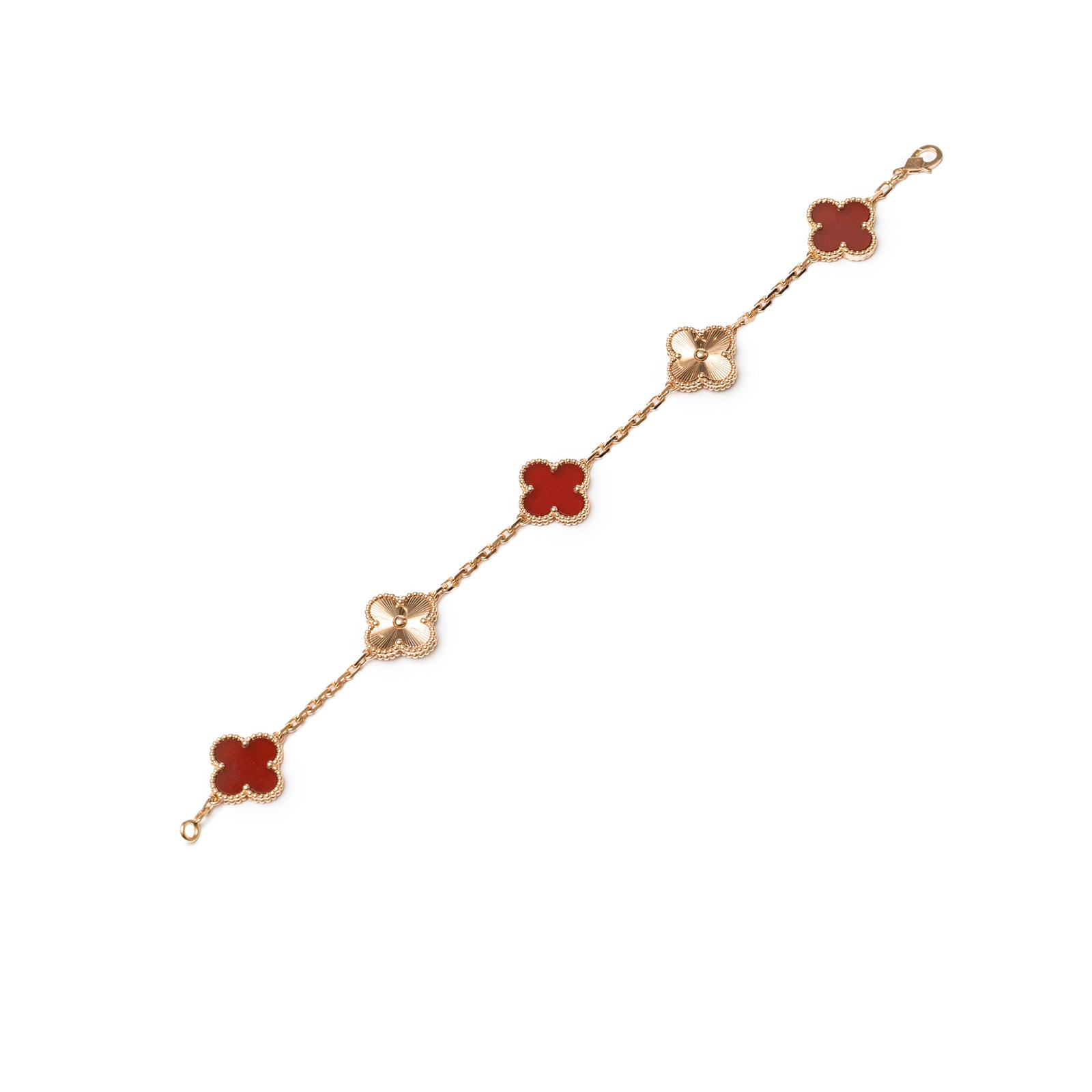 Flat lay of Van Cleef & Arpels Vintage Alhambra 5 Motifs Bracelet 18K Rose Gold Carnelian Guilloche angle view