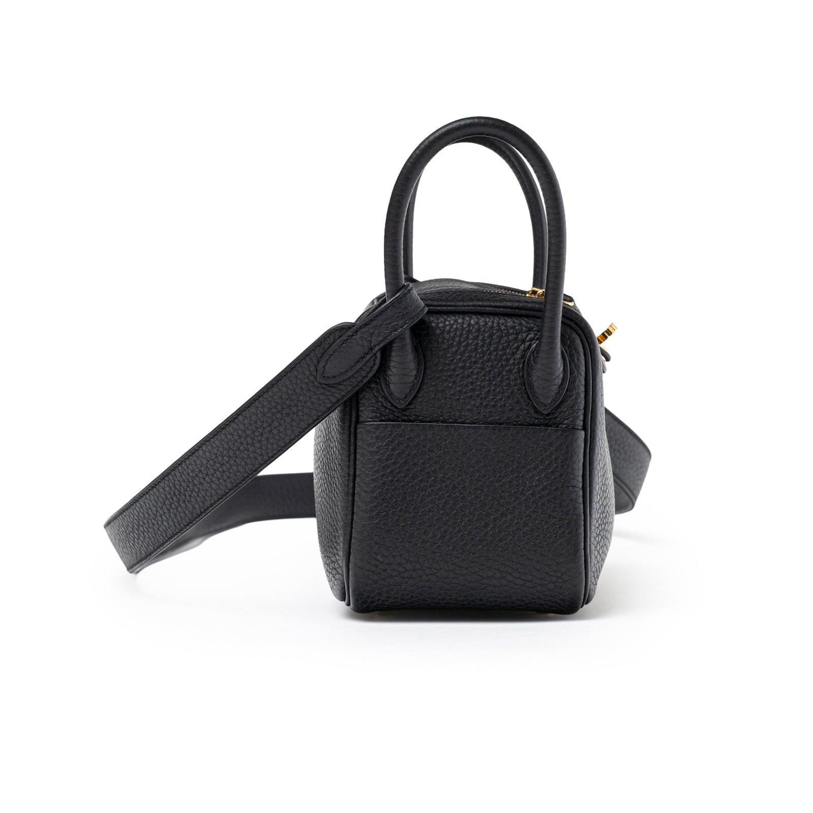 Side view of Hermès Mini Lindy I Black Clemence Gold Hardware with top handles and shoulder strap visible