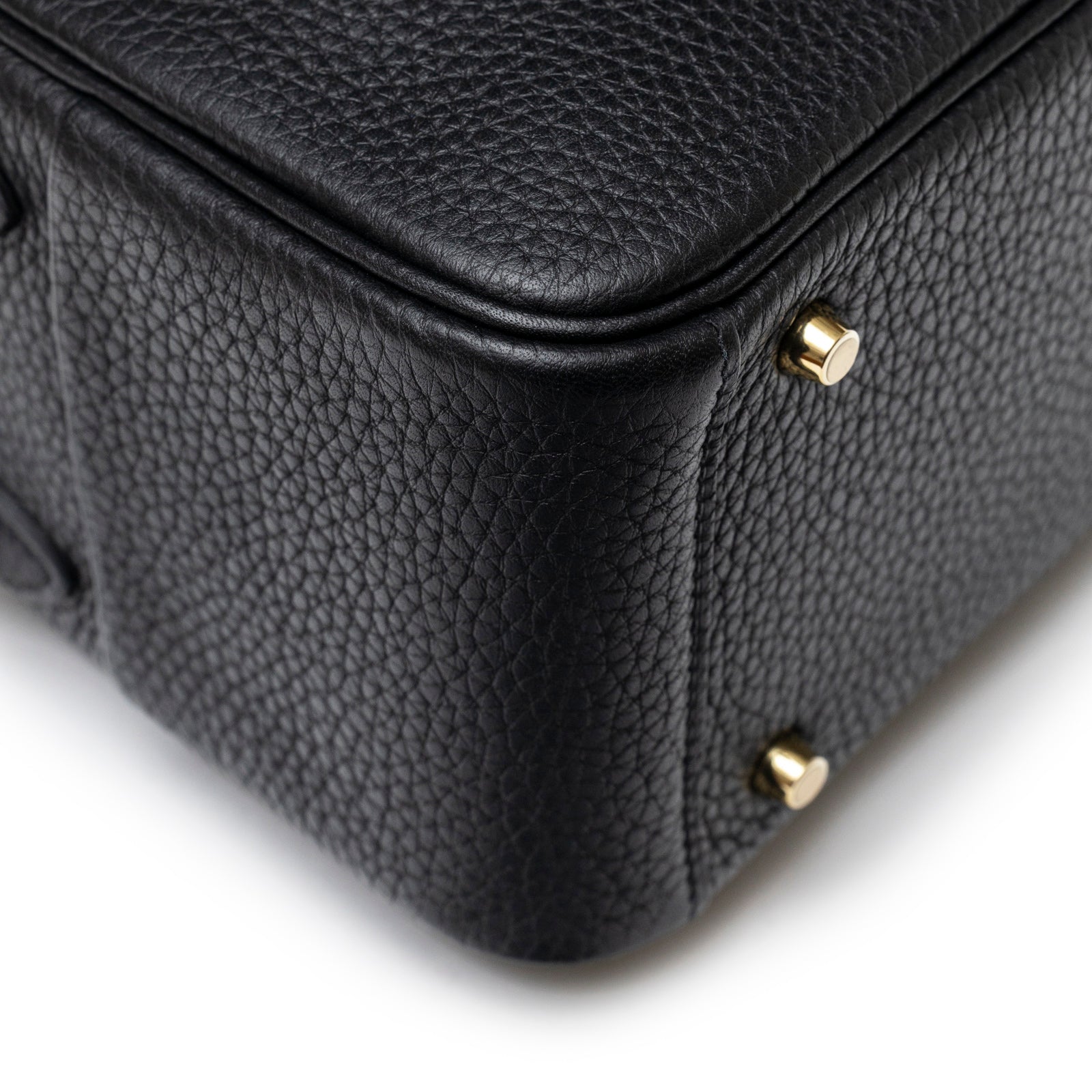 Close-up of Hermès Mini Lindy I Black Clemence Gold Hardware textured leather corner and gold feet details