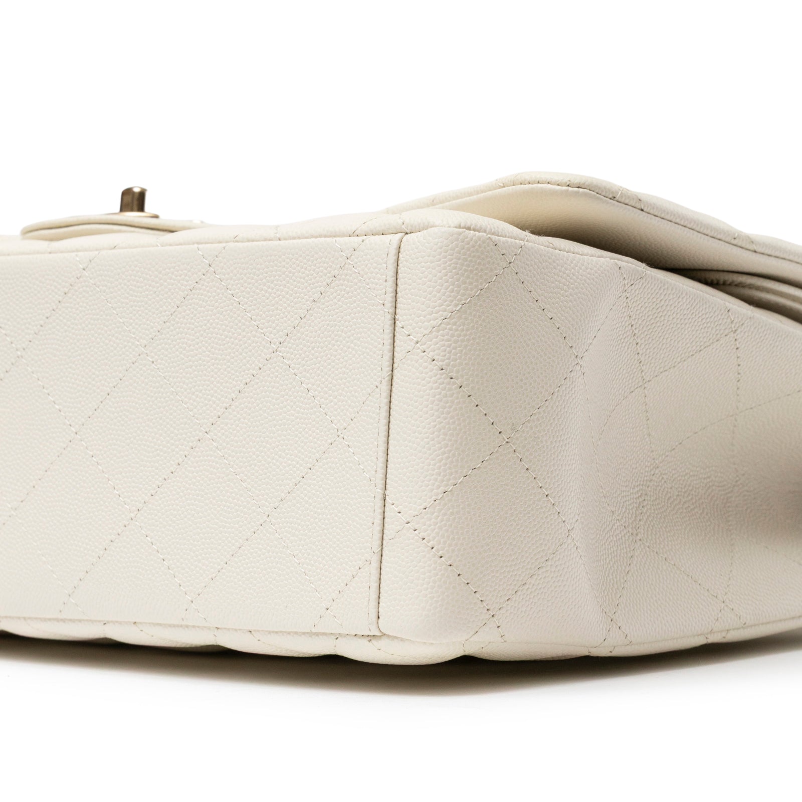 Close-up bottom view of Chanel Classic Flap Maxi Caviar White Gold Hardware showing quilted leather texture and stitching detail