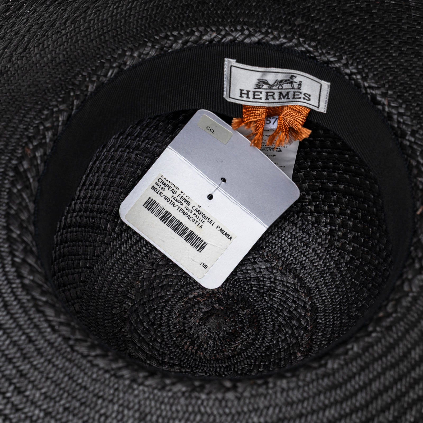 Inside view of Hermès Bride De Gala Straw Hat Black and Terracotta showing brand label and product tag details