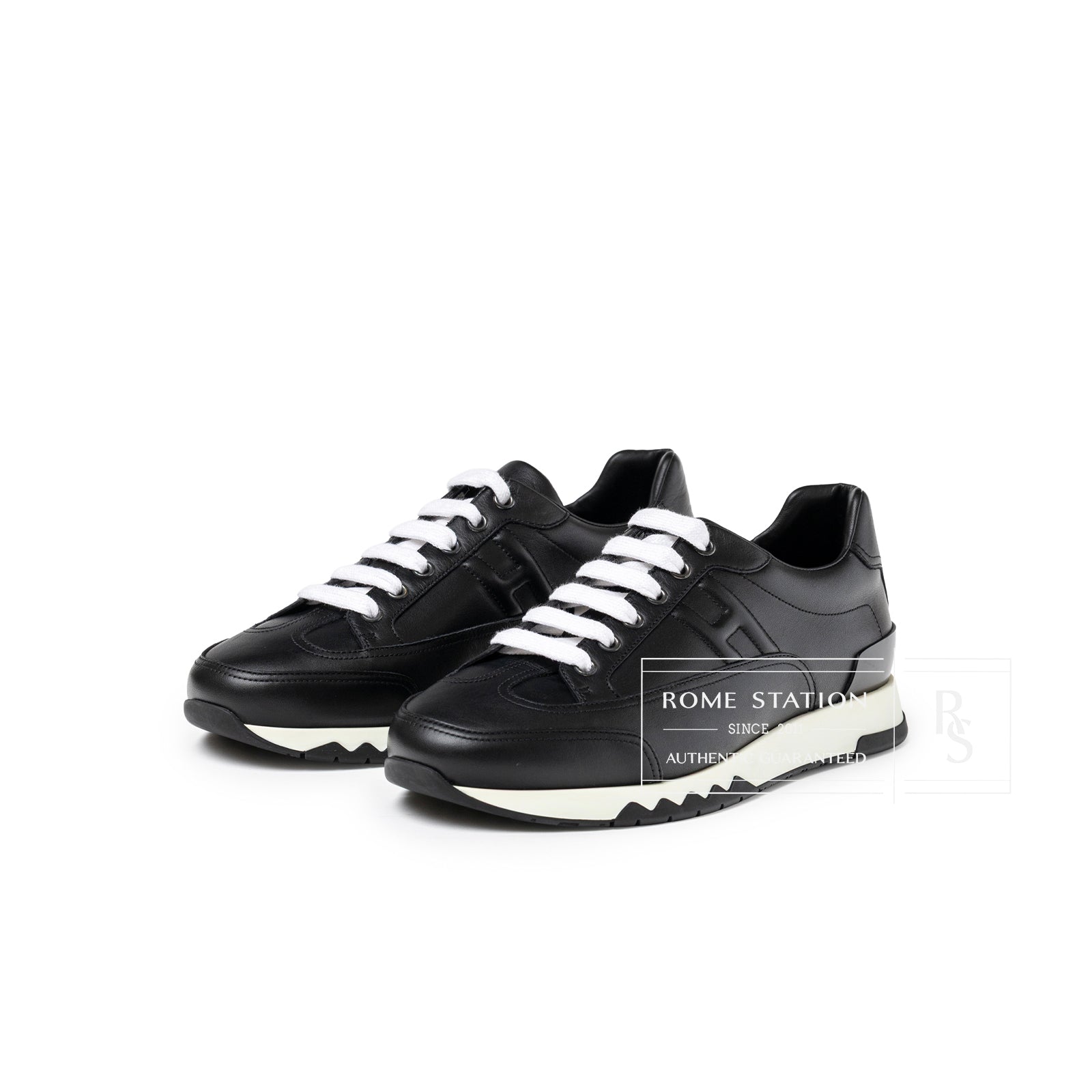 Angled front view of Hermès Men's Trail Sneaker Black with white laces and textured sole in size 41.5