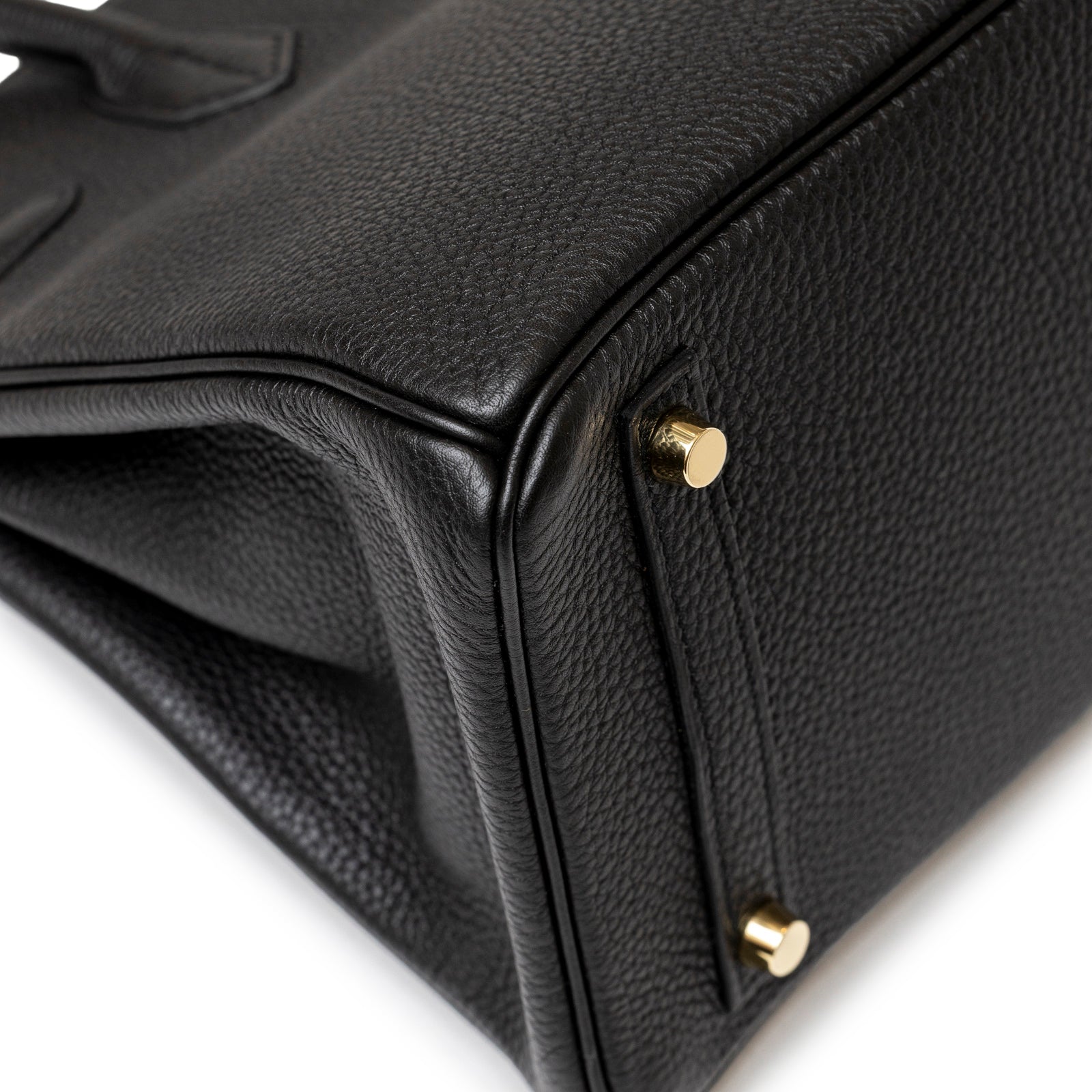 Close-up detailed view of textured leather and gold hardware on Hermès Birkin 30 Black Togo Gold Hardware bag.