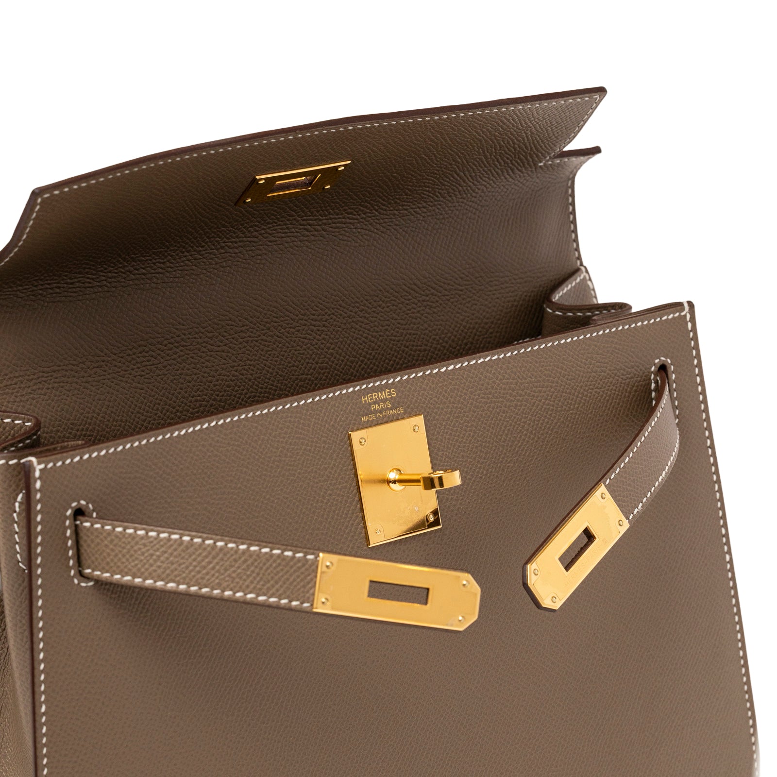 Close-up front view of Hermès Kelly 28 Sellier Etoupe Epsom Gold hardware showing open flap and stitching detail