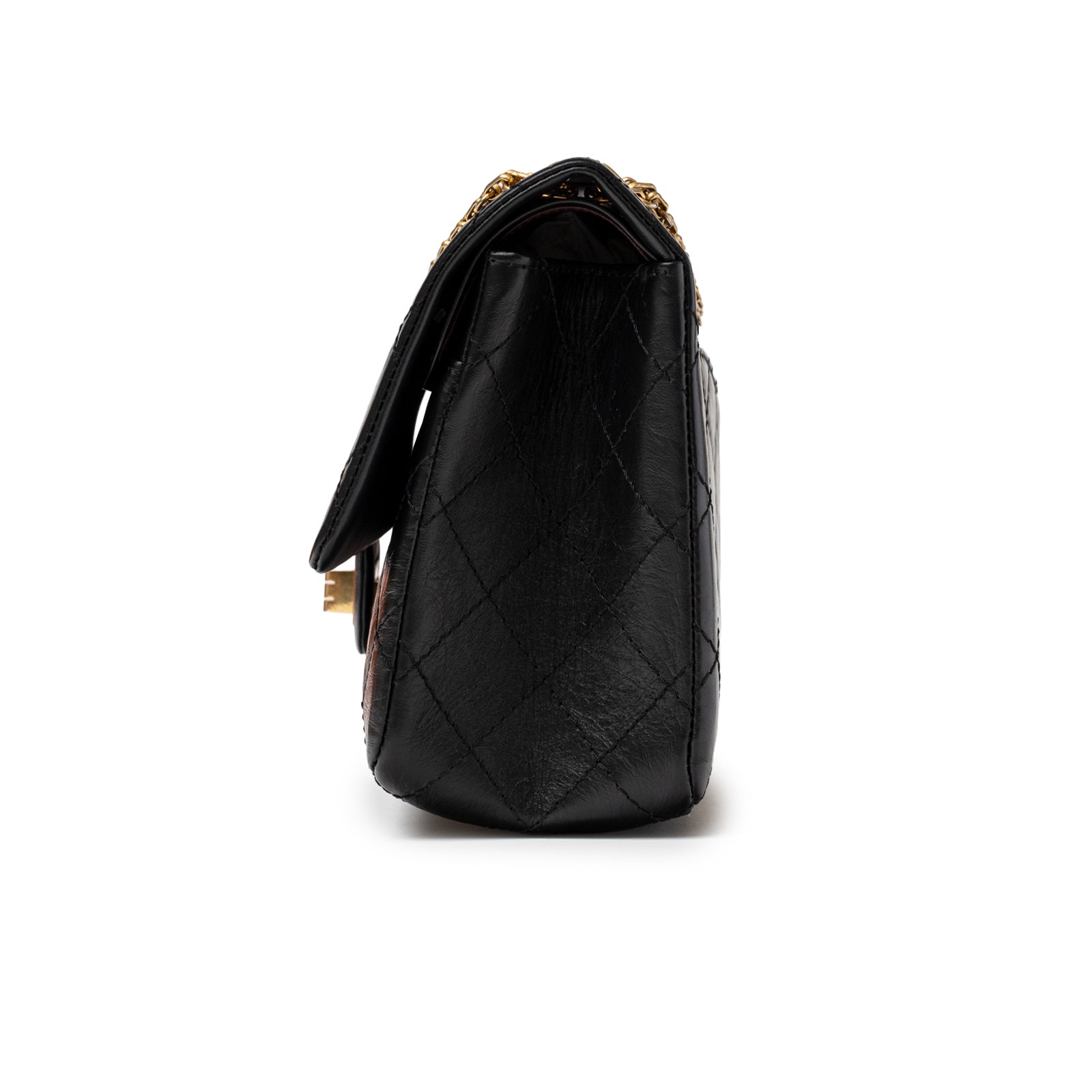 Side view of Chanel 2.55 Reissue 226 Flap Black Aged Calfskin Brushed Gold Hardware handbag showing quilted leather texture