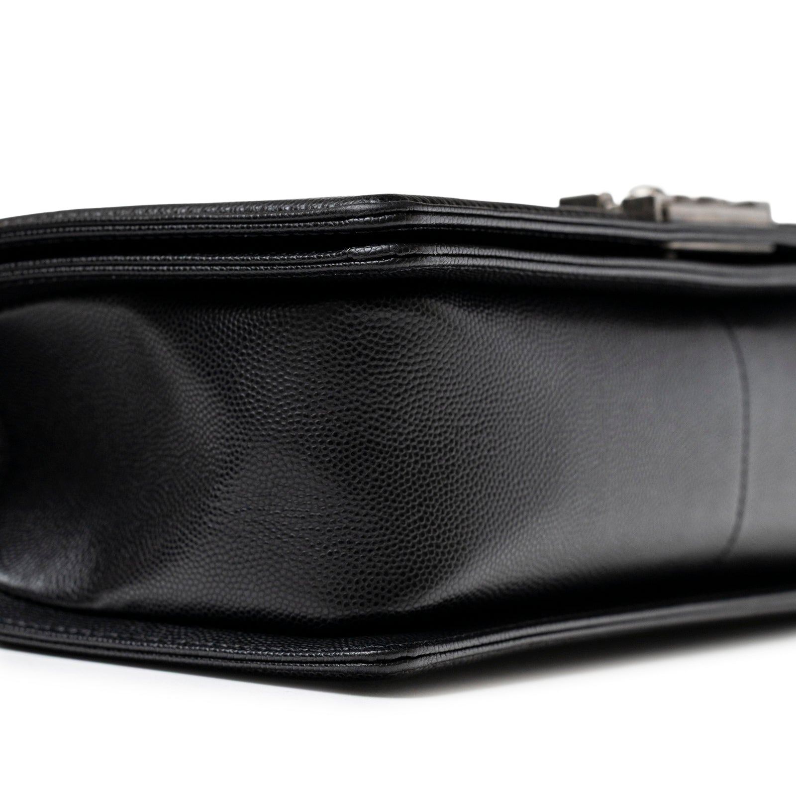 Close-up side view of Chanel Boy Bag Medium Black Caviar Aged Ruthenium Hardware showing textured leather detail
