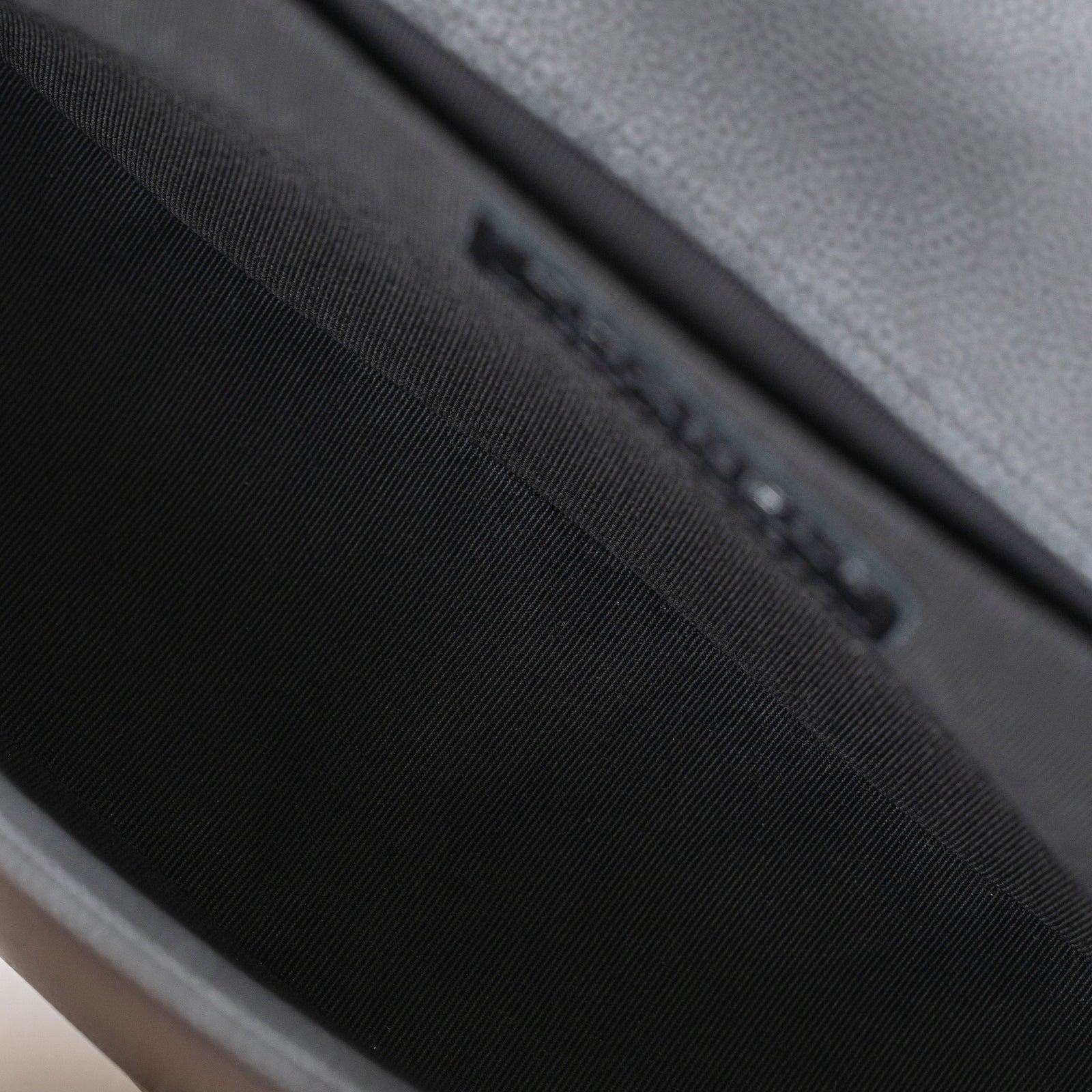 Interior close-up of the Chanel Boy Bag Medium Black Caviar Aged Ruthenium Hardware showing black fabric lining and stitched edges.