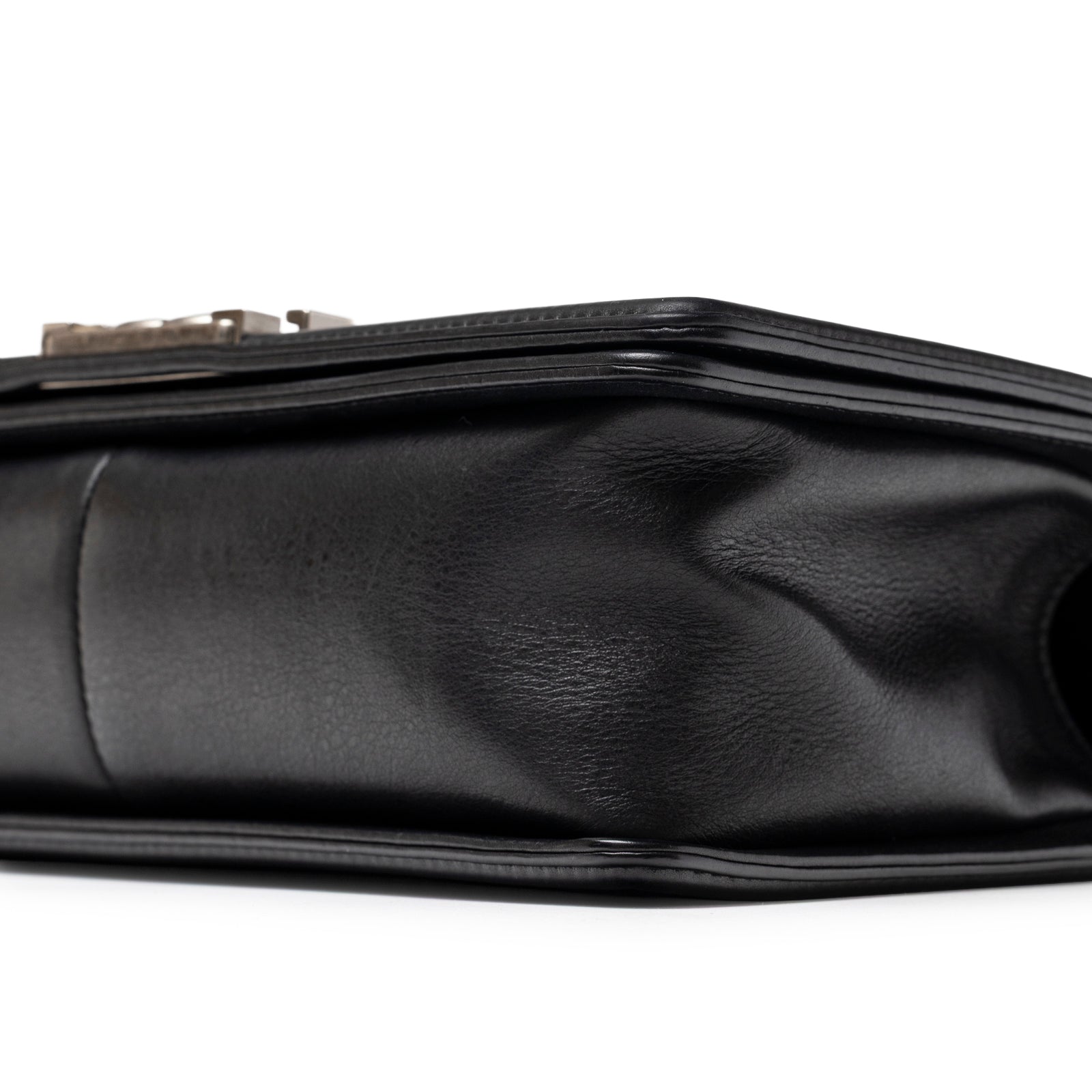 Close-up of bottom side showing soft texture on Chanel Boy Bag Medium Black Lambskin Ruthenium Hardware
