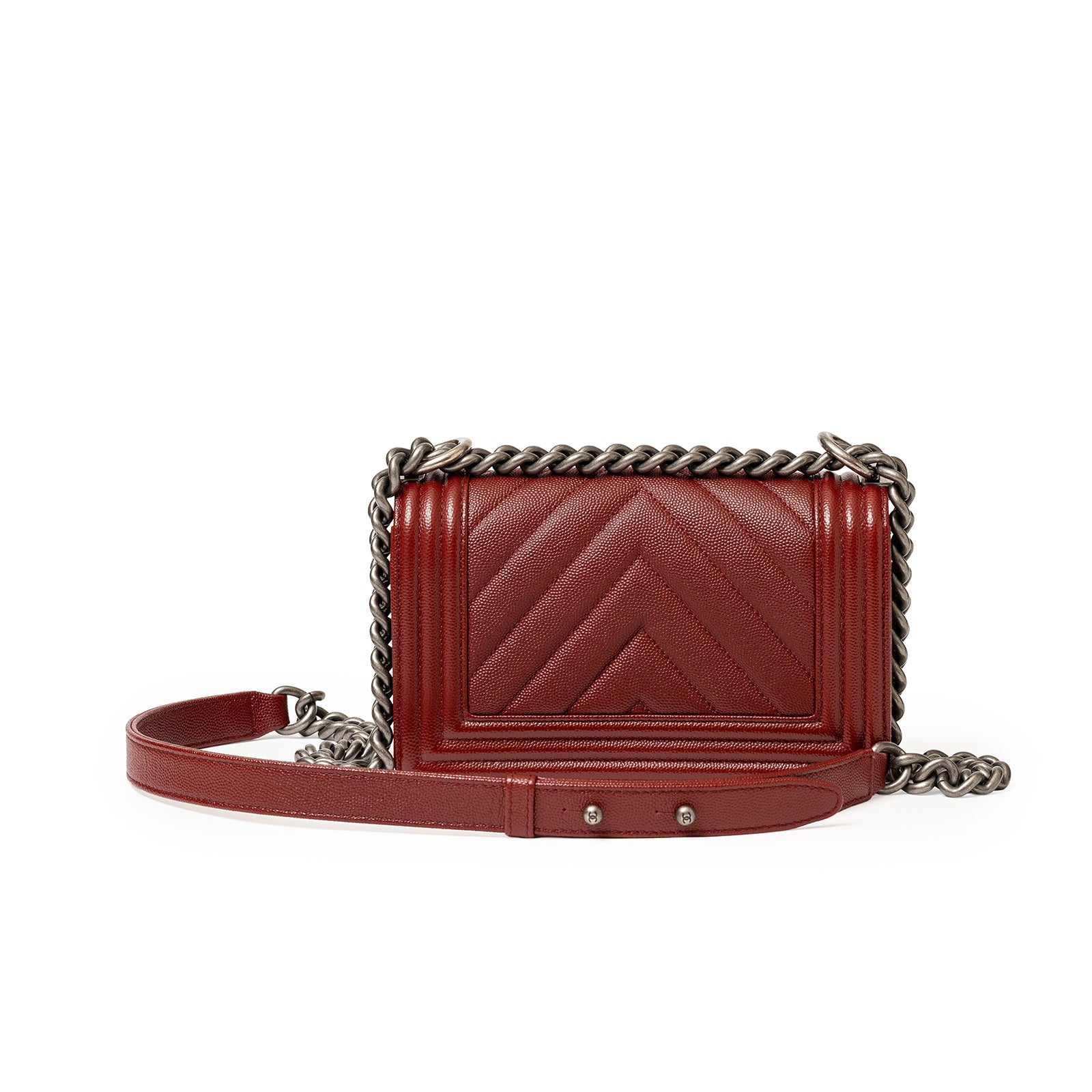 Front view of Chanel Small Boy Flap Bag Chevron Burgundy Caviar Palladium Hardware with chain strap laid flat