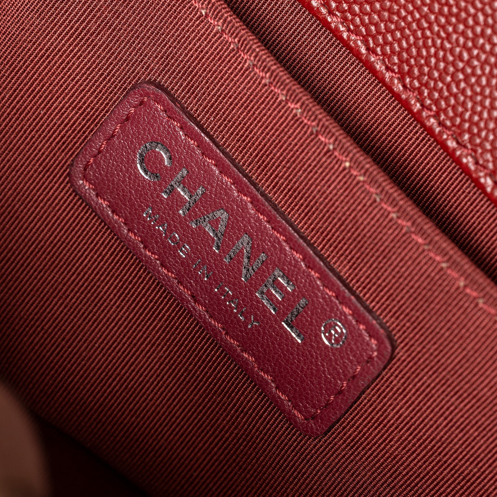 Close-up of interior label on Chanel Small Boy Flap Bag Chevron Burgundy Caviar Palladium Hardware showing Made in Italy tag