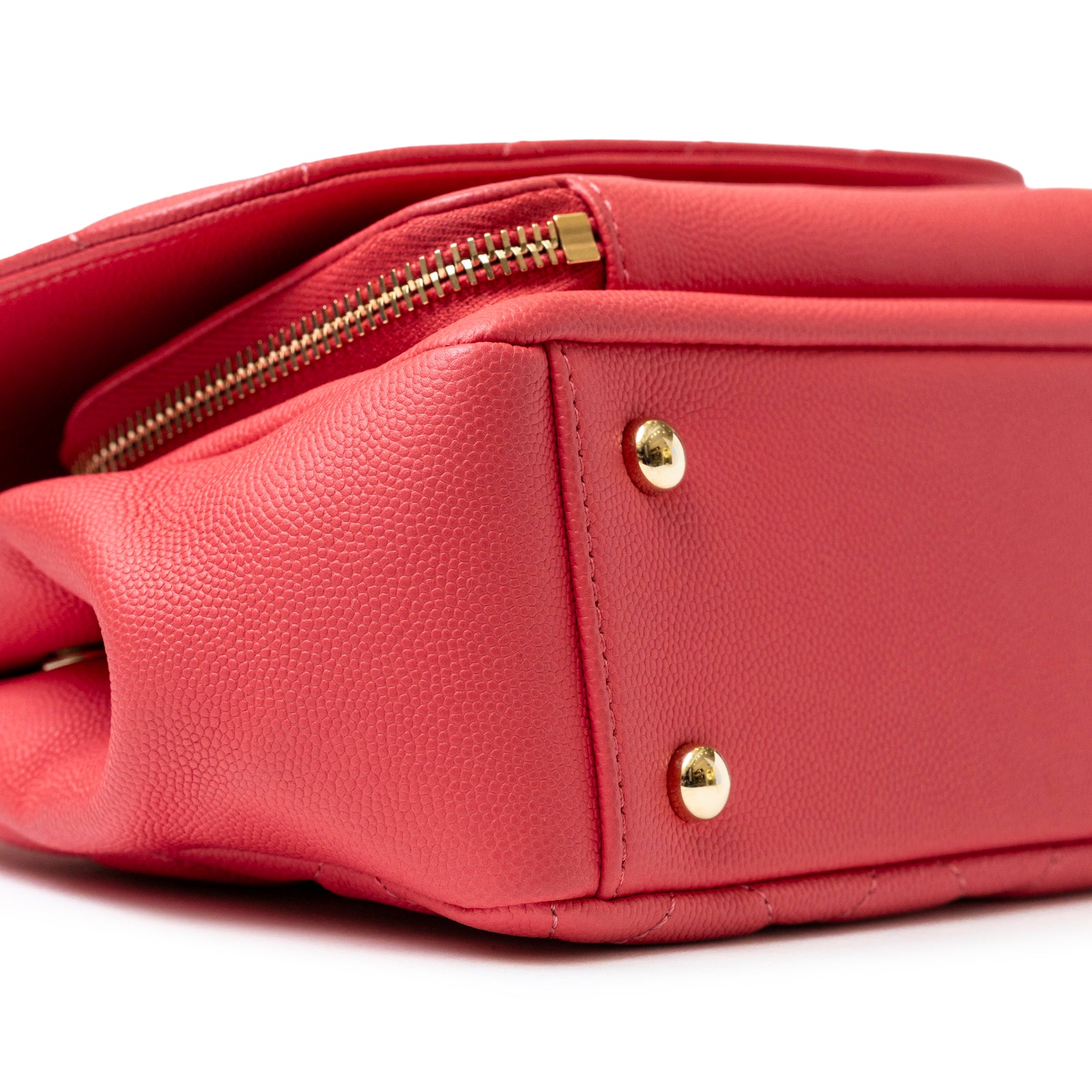 Close-up of the bottom corner of Chanel Business Affinity Small Flap Bag Pink Caviar Light Gold Hardware showing texture and zipper detail.