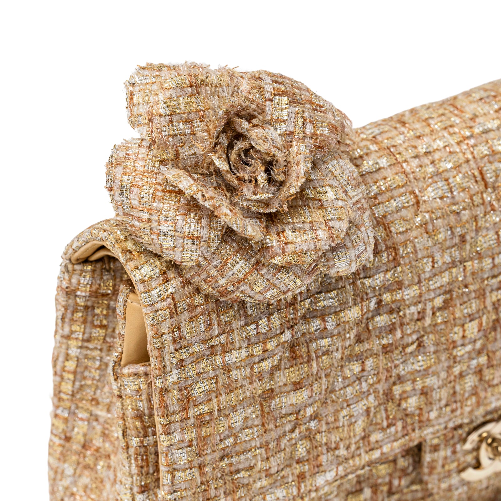 Close-up angled view of Chanel Camellia Gold Beige Tweed Brooch on Chanel Classic Medium Double Flap 