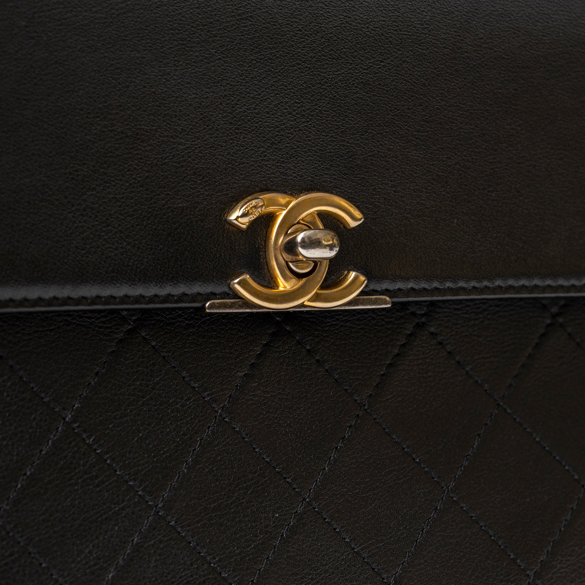Chanel Clutch Black Quilted Lambskin Gold and Palladium Hardware CC clasp close up