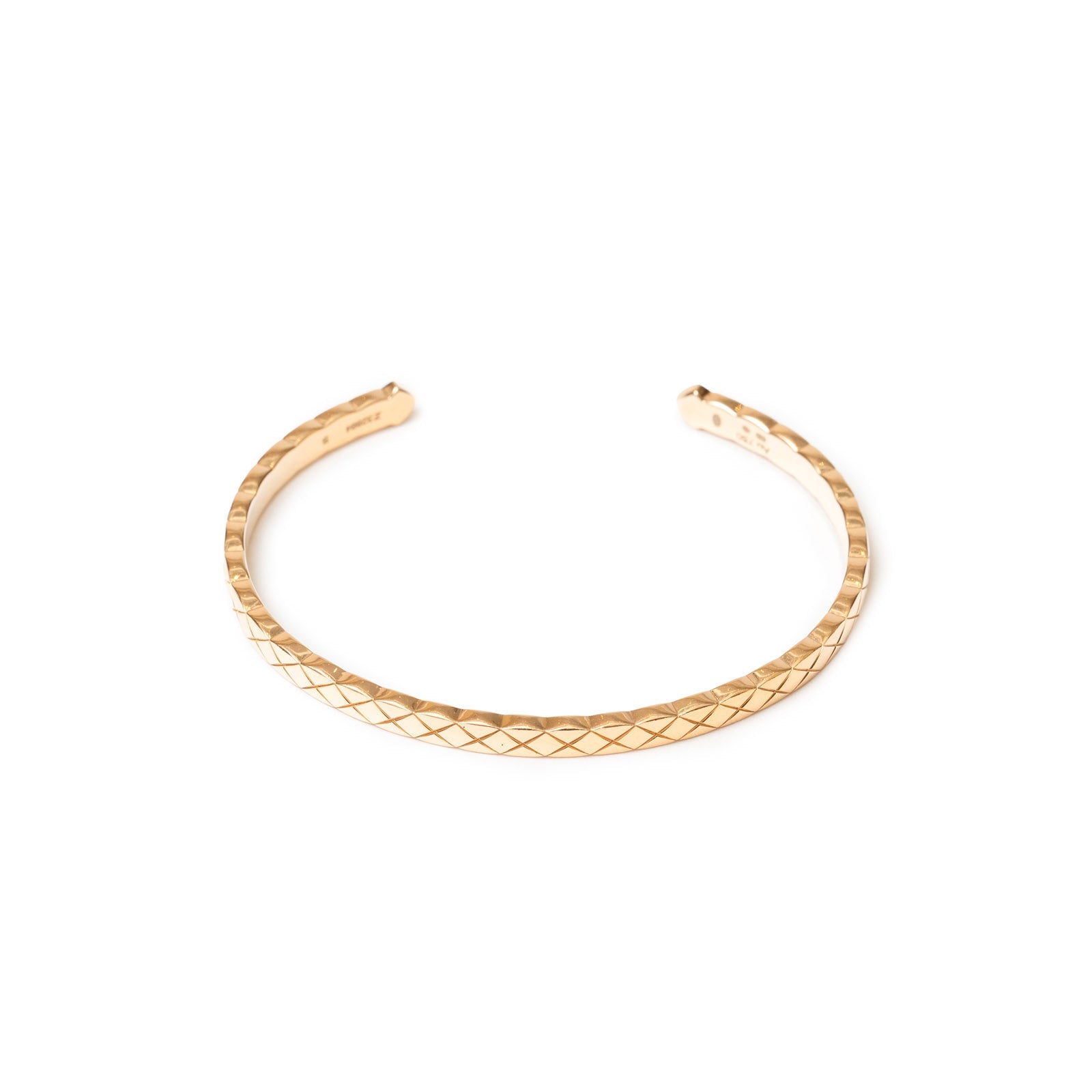 Angled close-up of Chanel Coco Crush Mini Bracelet 18K Gold Au750 showing quilted pattern on slim band