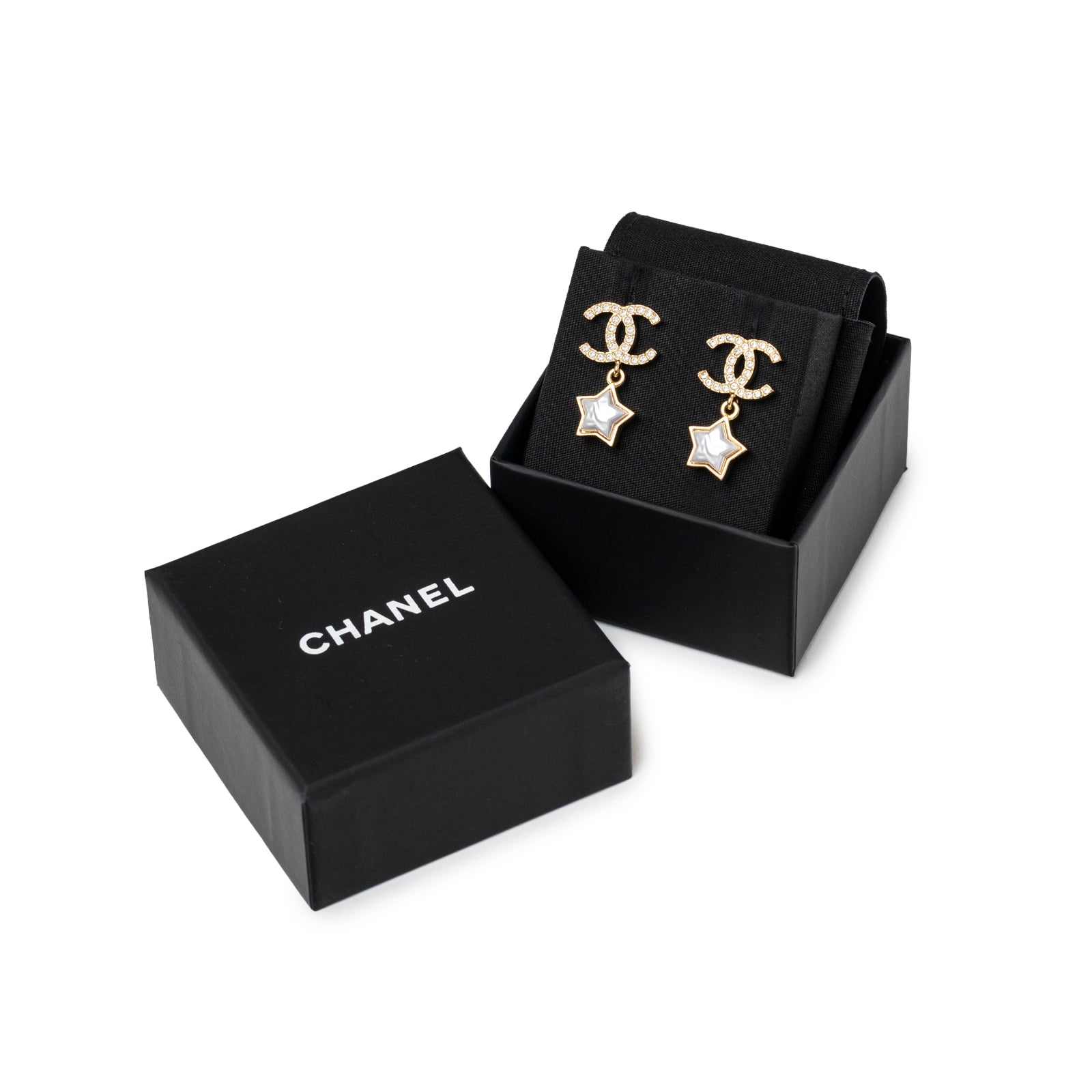 Chanel Crystal and Pearl CC Star Dangle Earrings Gold Hardware displayed in black Chanel box with soft interior lining