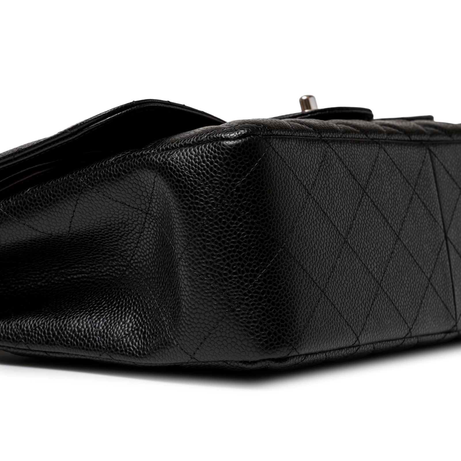 Close-up angled shot of Chanel Jumbo Classic Double Flap Caviar Black Palladium Hardware showing quilted leather corner detail.