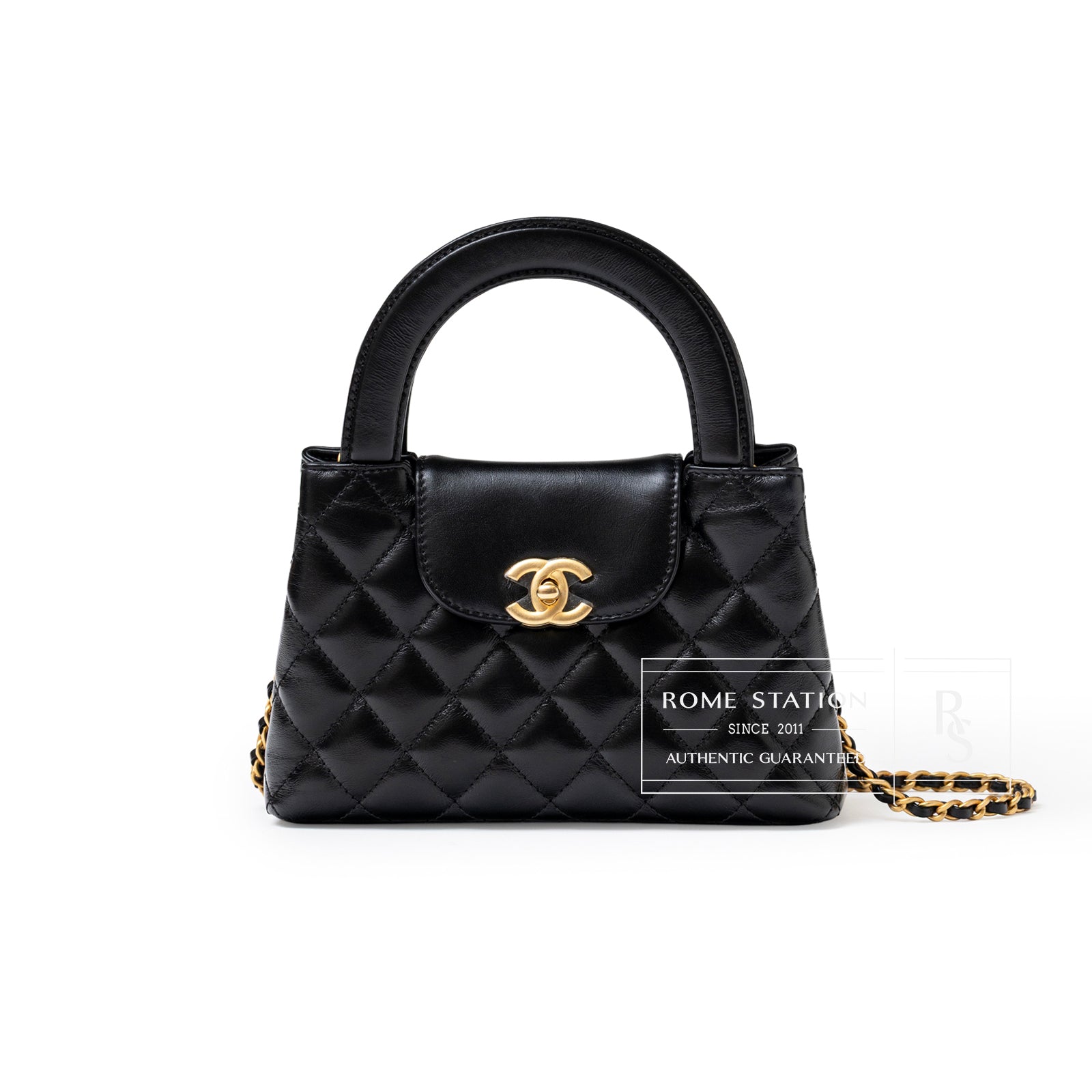 Front view of Chanel Mini Kelly Shopper Black Shiny Aged Calfskin Brushed Gold Hardware with quilted texture and chain strap