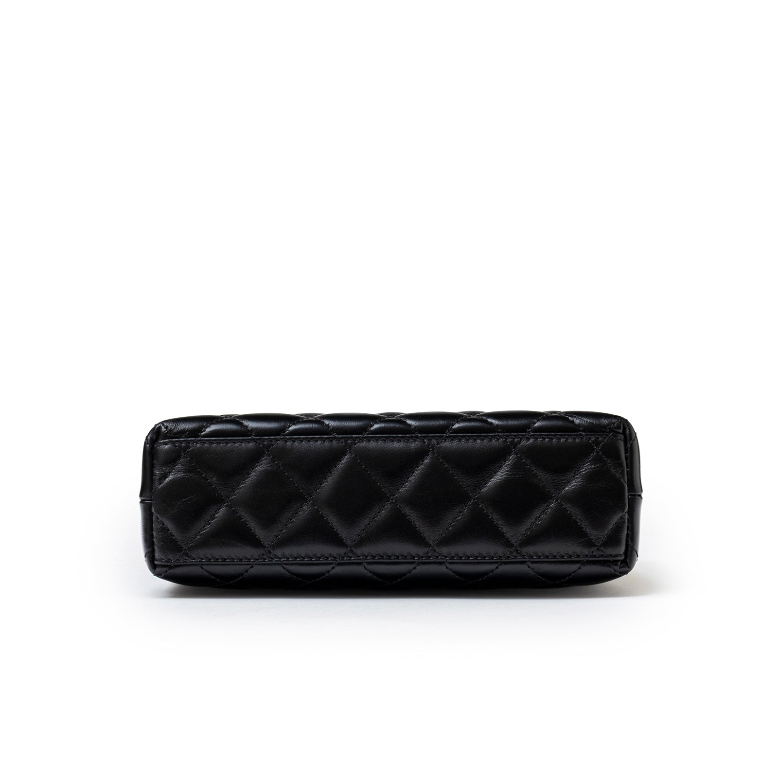 Bottom view of Chanel Mini Kelly Shopper Black Shiny Aged Calfskin Brushed Gold Hardware showcasing quilted leather base