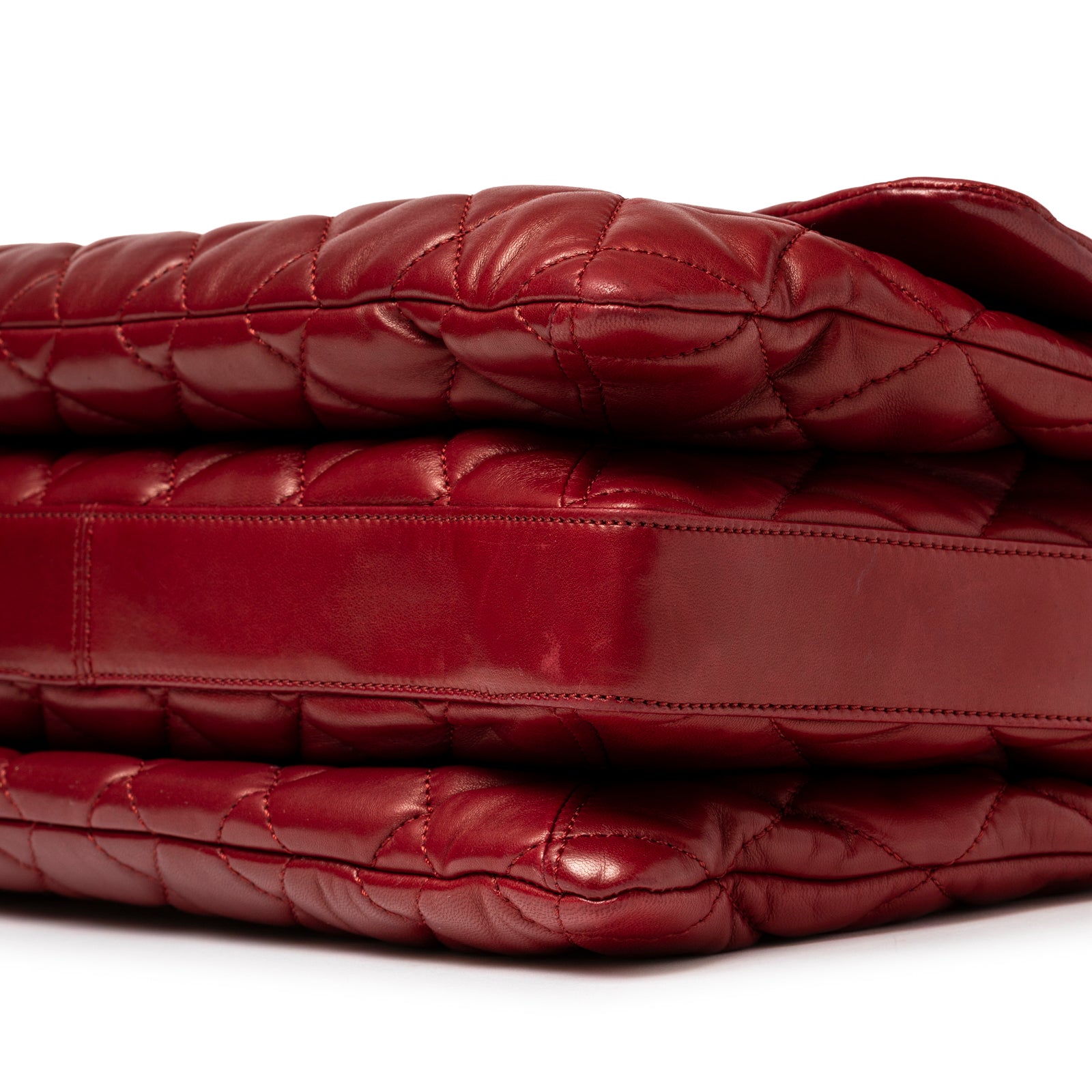 Corner close-up of Chanel Maxi 3 Accordion Flap Bag Lambskin Red Palladium Hardware showing quilted leather and smooth base panel