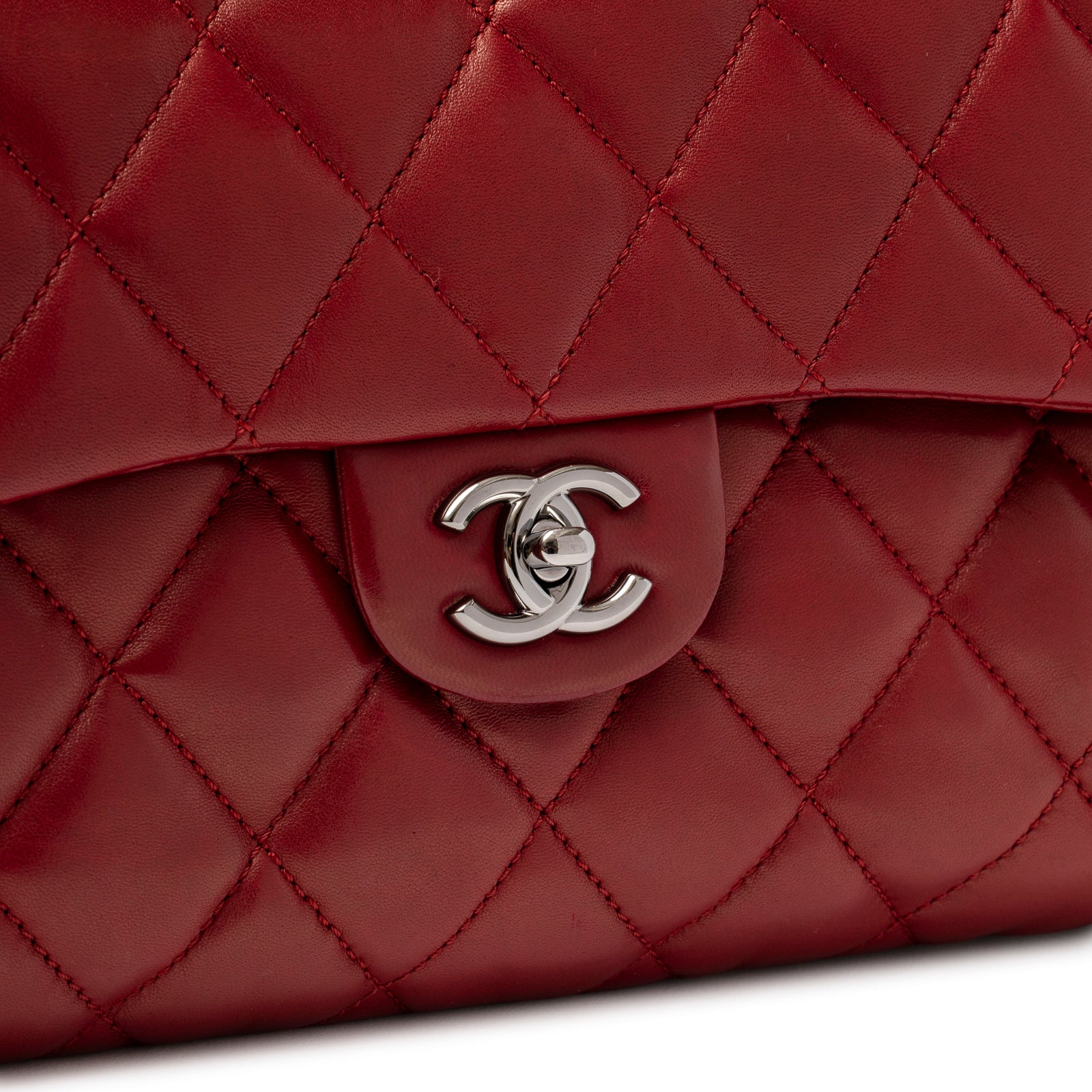 Close-up of Chanel Maxi 3 Accordion Flap Bag Lambskin Red Palladium Hardware showing silver CC turn-lock clasp and quilted leather