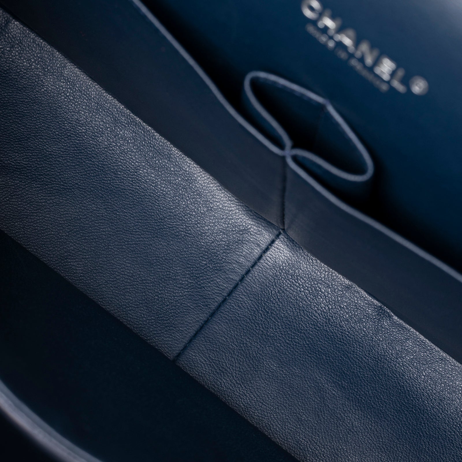 Interior close-up of Chanel Maxi Classic Double Flap Caviar Navy Palladium Hardware showing smooth navy leather lining and stitching detail